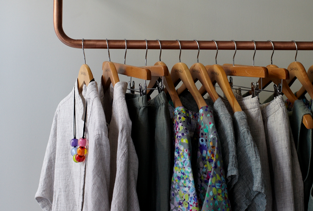 rail with clothes on hangers