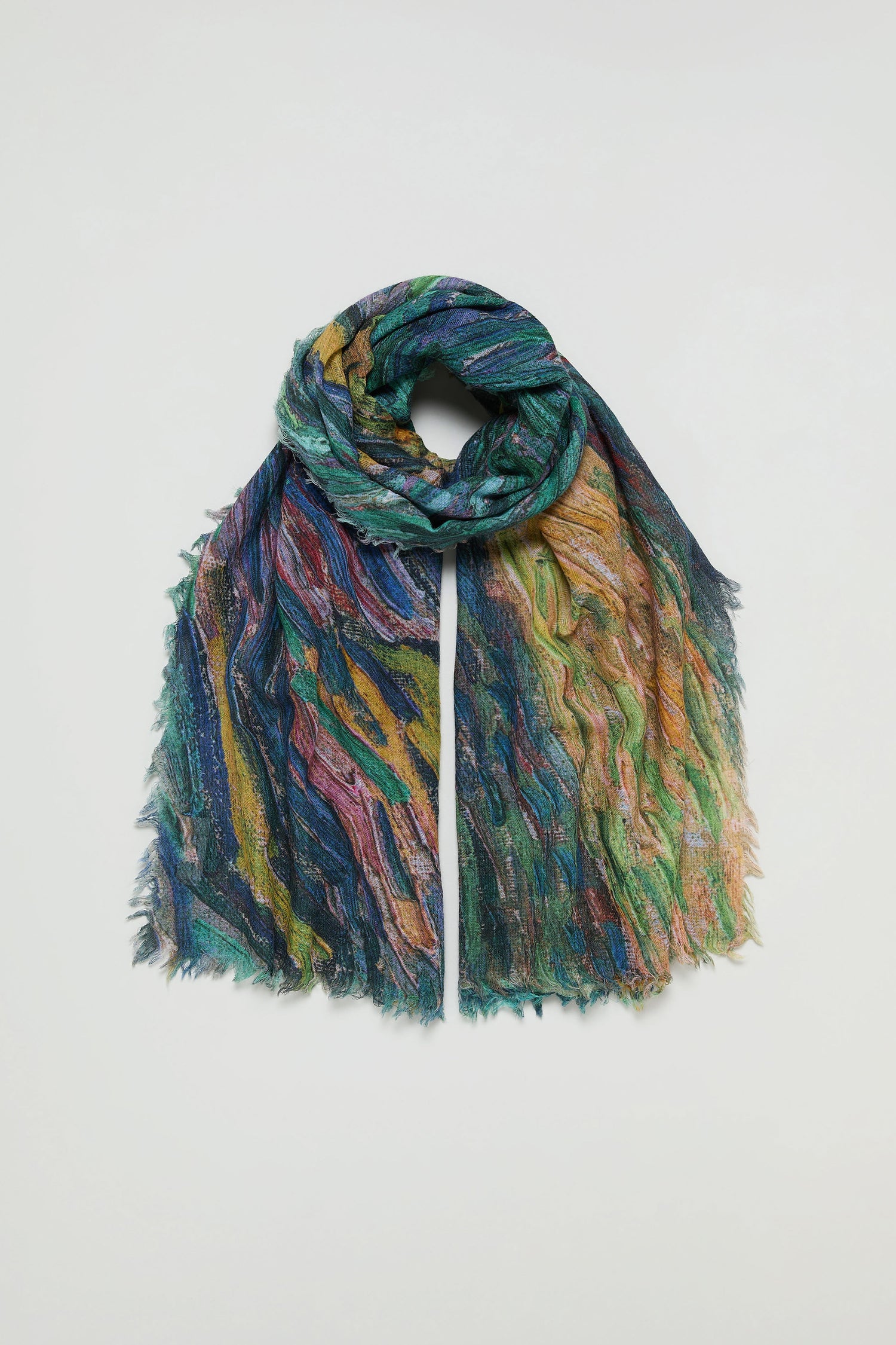 The Painter's Landscape Wool Scarf, featuring a multicolored textured wool blend and fringe edges, is displayed flat on a plain white background.