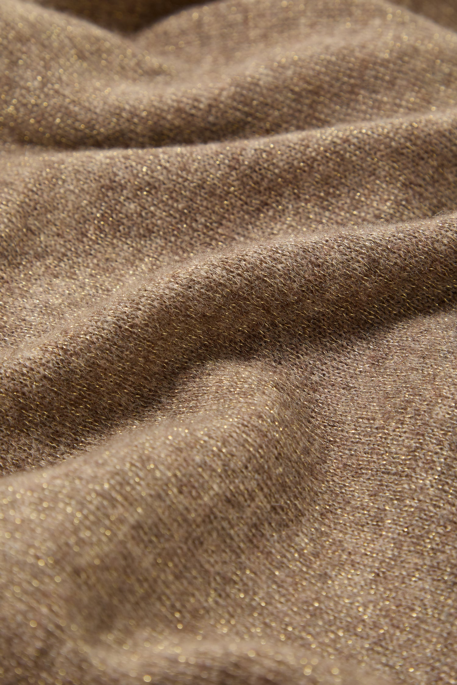 Close-up of the Cashmere Sparkle Scarf—a soft, brown neutral-toned accessory featuring a subtle gold shimmer and gentle folds.
