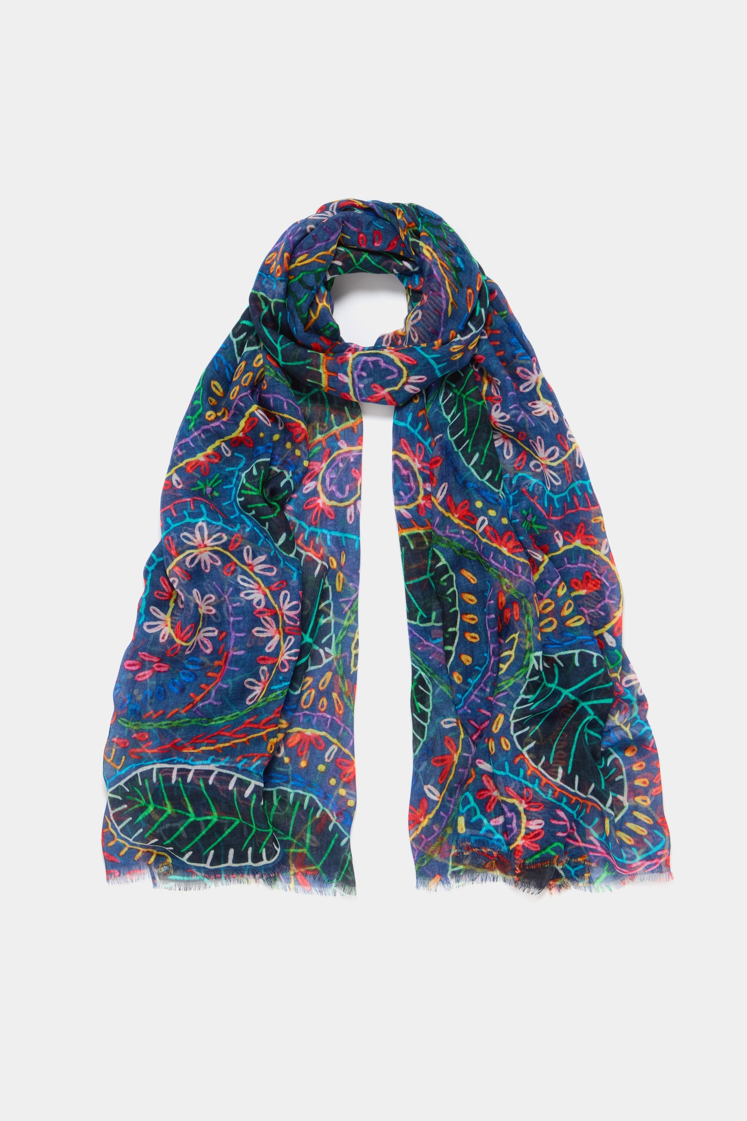 The Painted Leaves Modal Scarf boasts a dark blue background with colorful, intricate hand-painted leaf and floral motifs, crafted from luxuriously soft modal fabric.