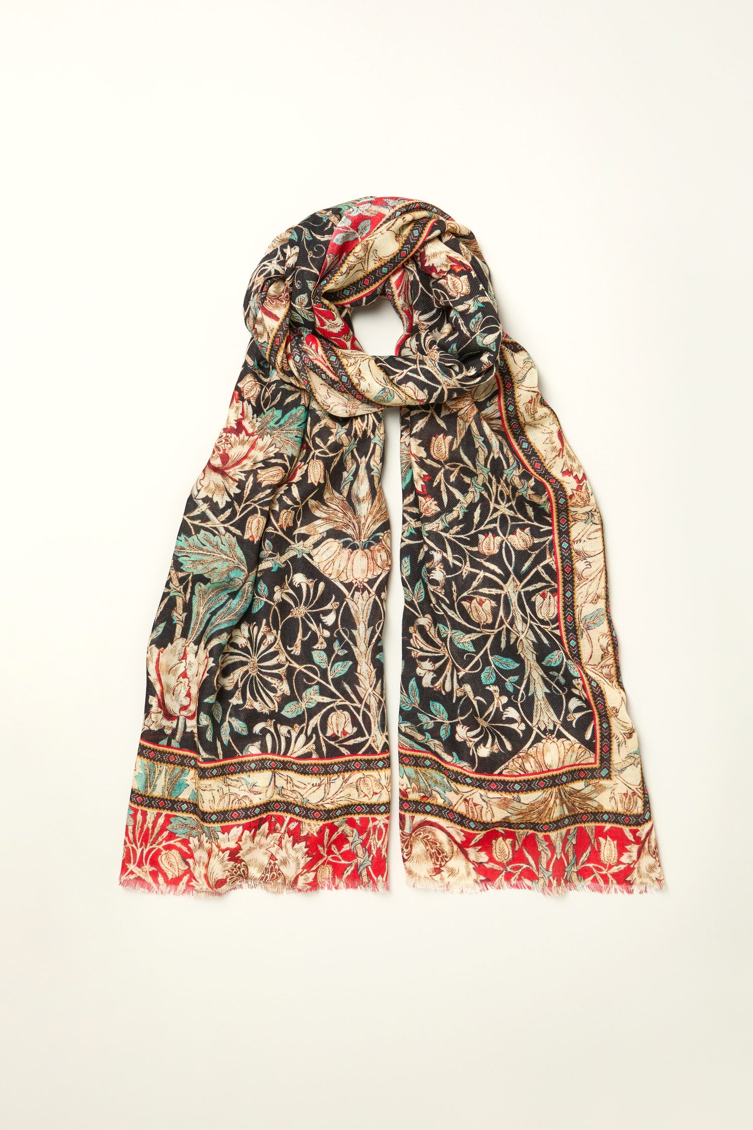 The Ornamental Floral Wool Mix Scarf features black, red, beige, and green leaf patterns in a rectangular shape, shown flat on a white background.
