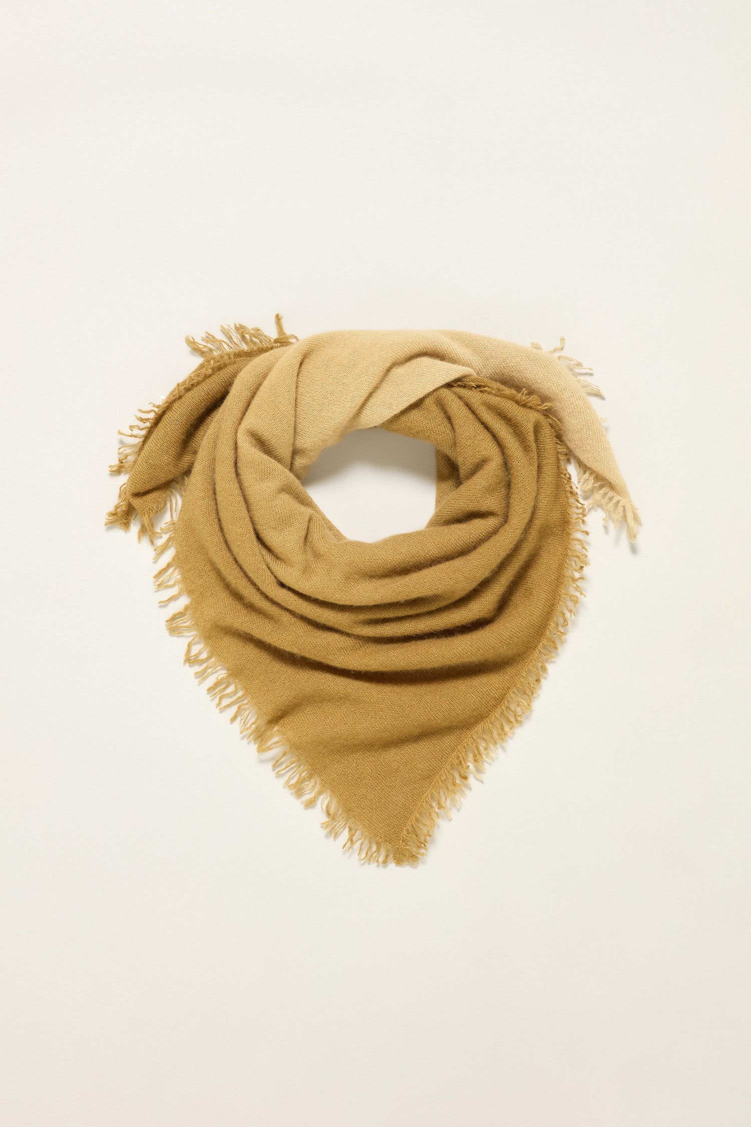 The Ombre Cashmere Square Scarf features a tan and beige ombre pattern in soft cashmere with fringed edges, styled flat on a neutral background for an elegant, luxurious look.
