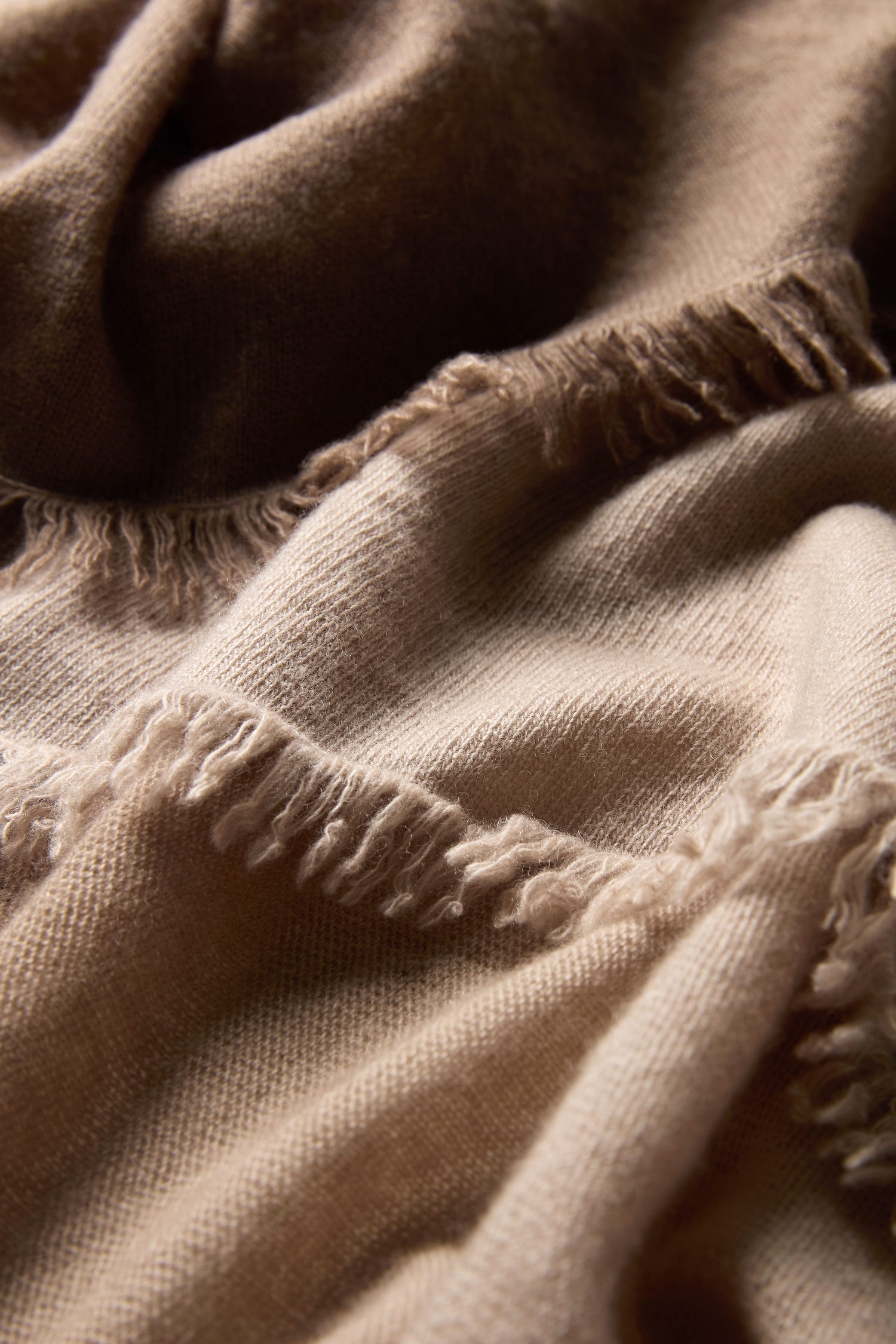 Close-up of the Ombre Cashmere Square Scarf in light brown, featuring a soft, textured surface with visible woven fibers and elegant fringe—ideal for those seeking a luxurious ombre accessory.