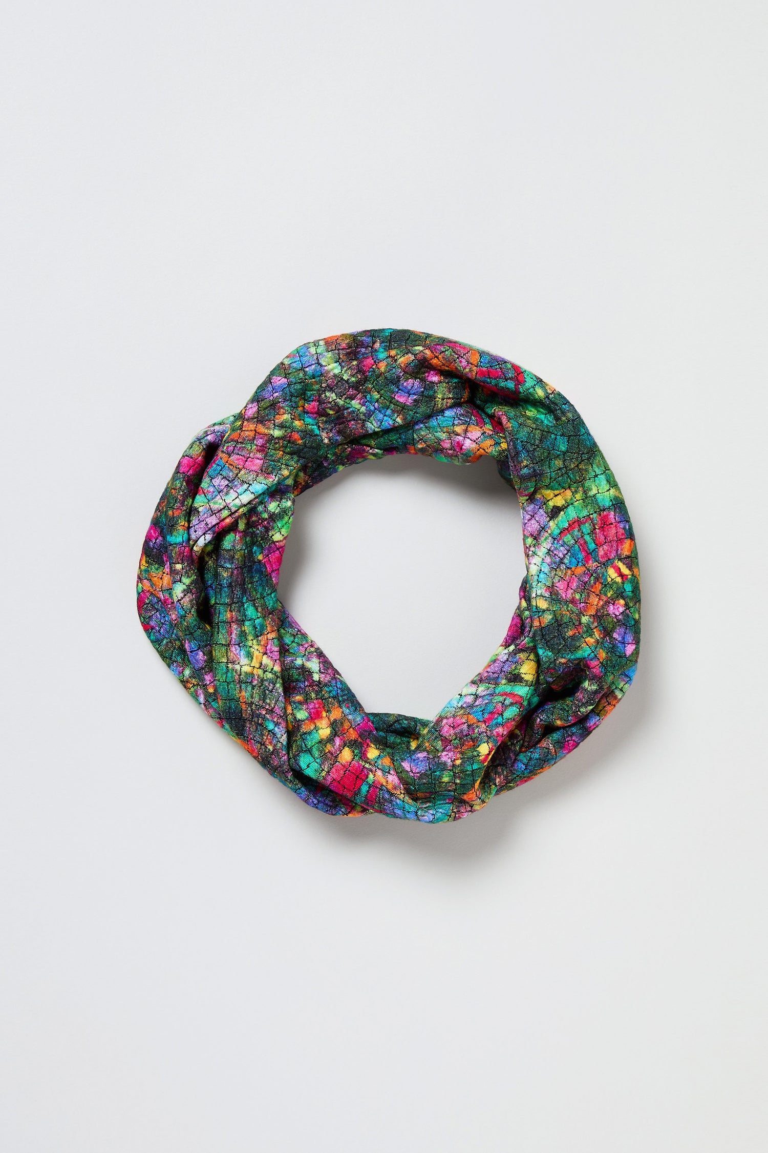The Circle Textured Snood, featuring a multicolour circle print, is displayed in a circular shape on a plain white background.