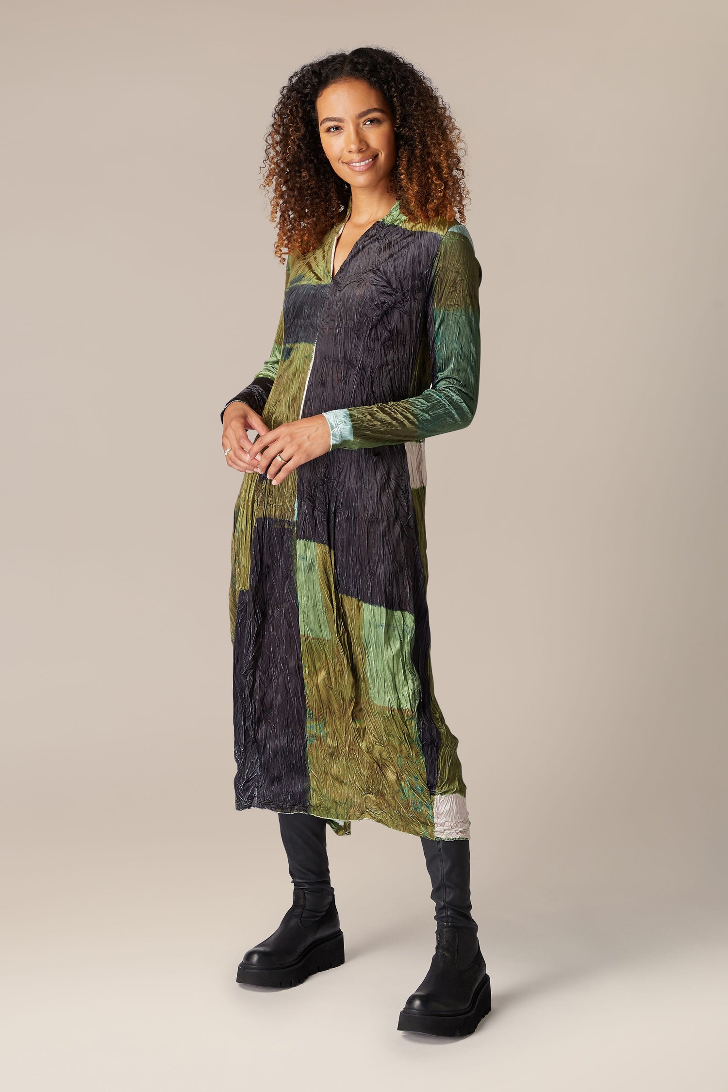 A woman wearing a green Block Velvet Dress.