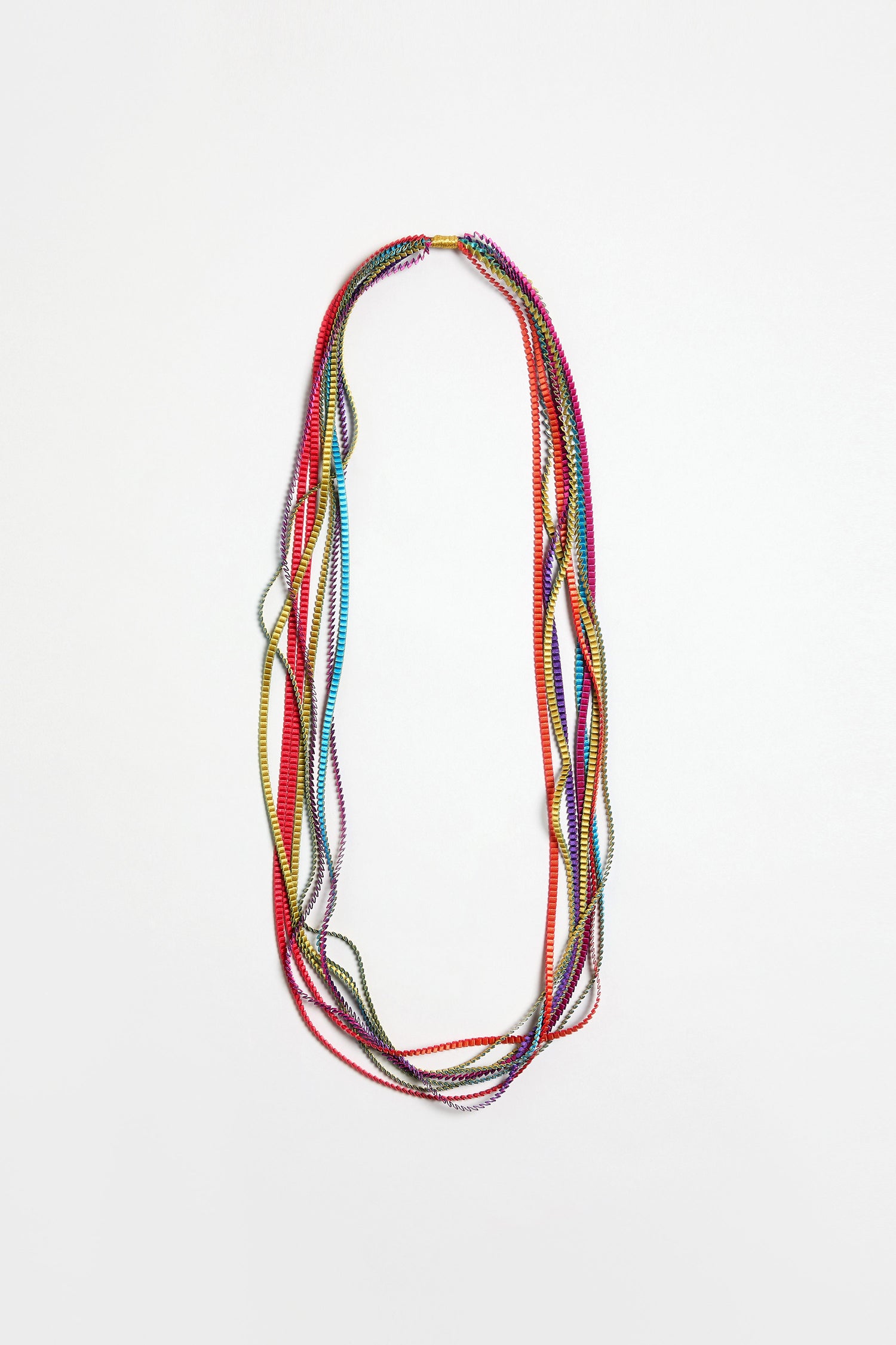 The Long Pleated Necklace features thin, colorful beads arranged in multiple loops, making it a striking statement accessory against a plain white background.