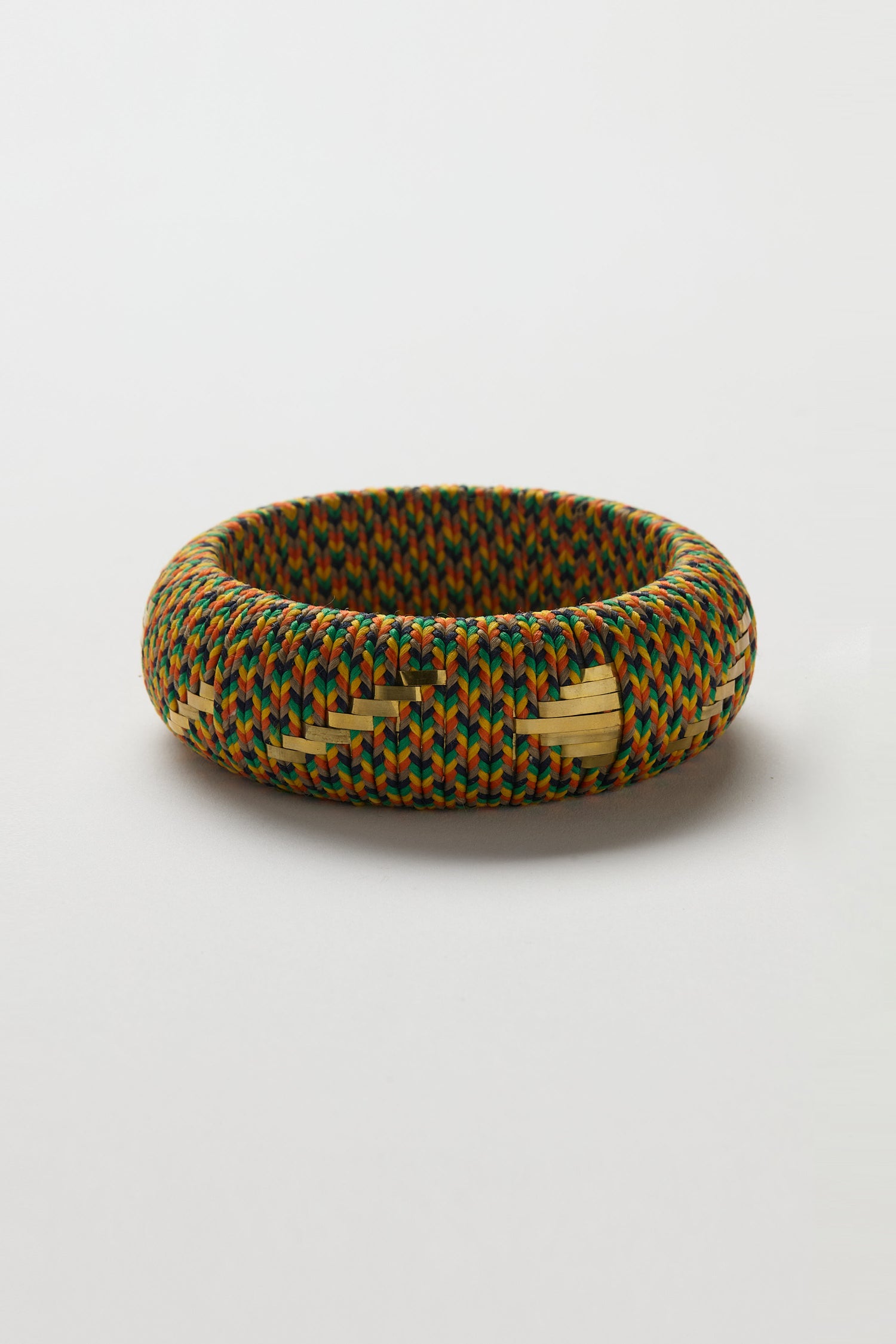 The Handwoven Multicoloured Bangle features a vibrant, multicolored pattern crafted from bright threads, highlighting heritage craftsmanship and shown against a plain white background.