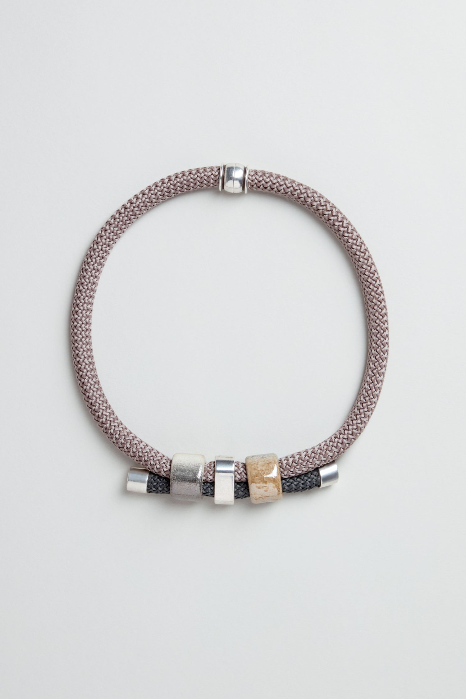 The braided bracelet with silver and gold-tone beads pairs beautifully with the Layered Marble Bead Cord Necklace for an elegant, coordinated look.