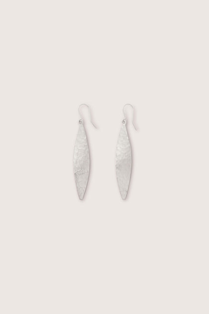 A pair of Hammered Silver Leaf Earrings, designed with elongated shapes and hooks, displayed against a light background.