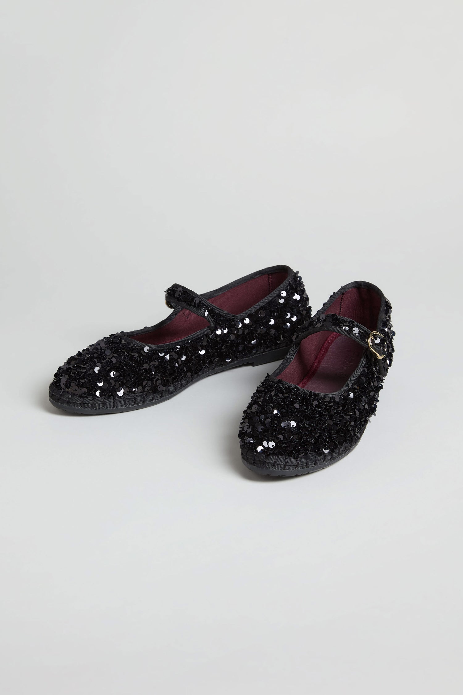 Sequin Mary Jane Velvet Shoes in black with low heels and buckle straps, handmade in Spain, displayed against a plain light background.