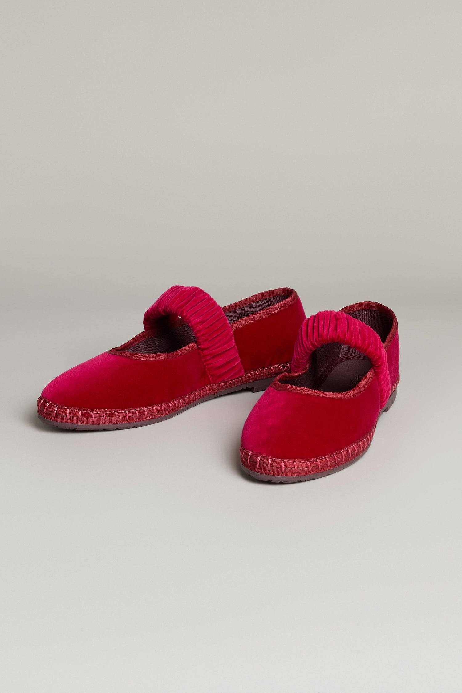 The Mafalda Fuchsia Velvet Shoes feature elastic ruched straps and visible stitching on a recycled rubber sole, shown against a plain light background.