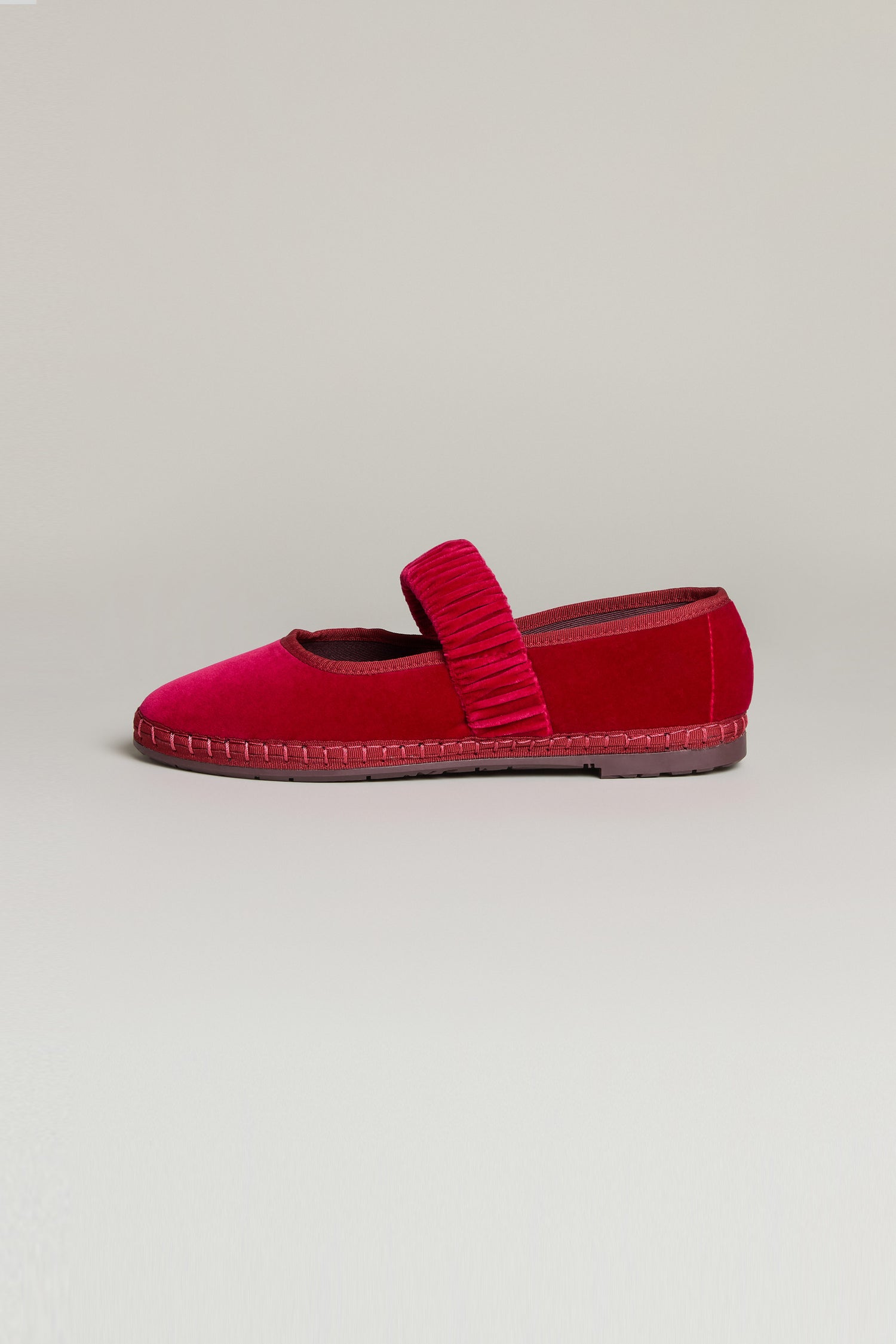 A single Mafalda Fuchsia Velvet Shoe with a textured elastic strap across the top and a recycled rubber sole, displayed against a plain light background.