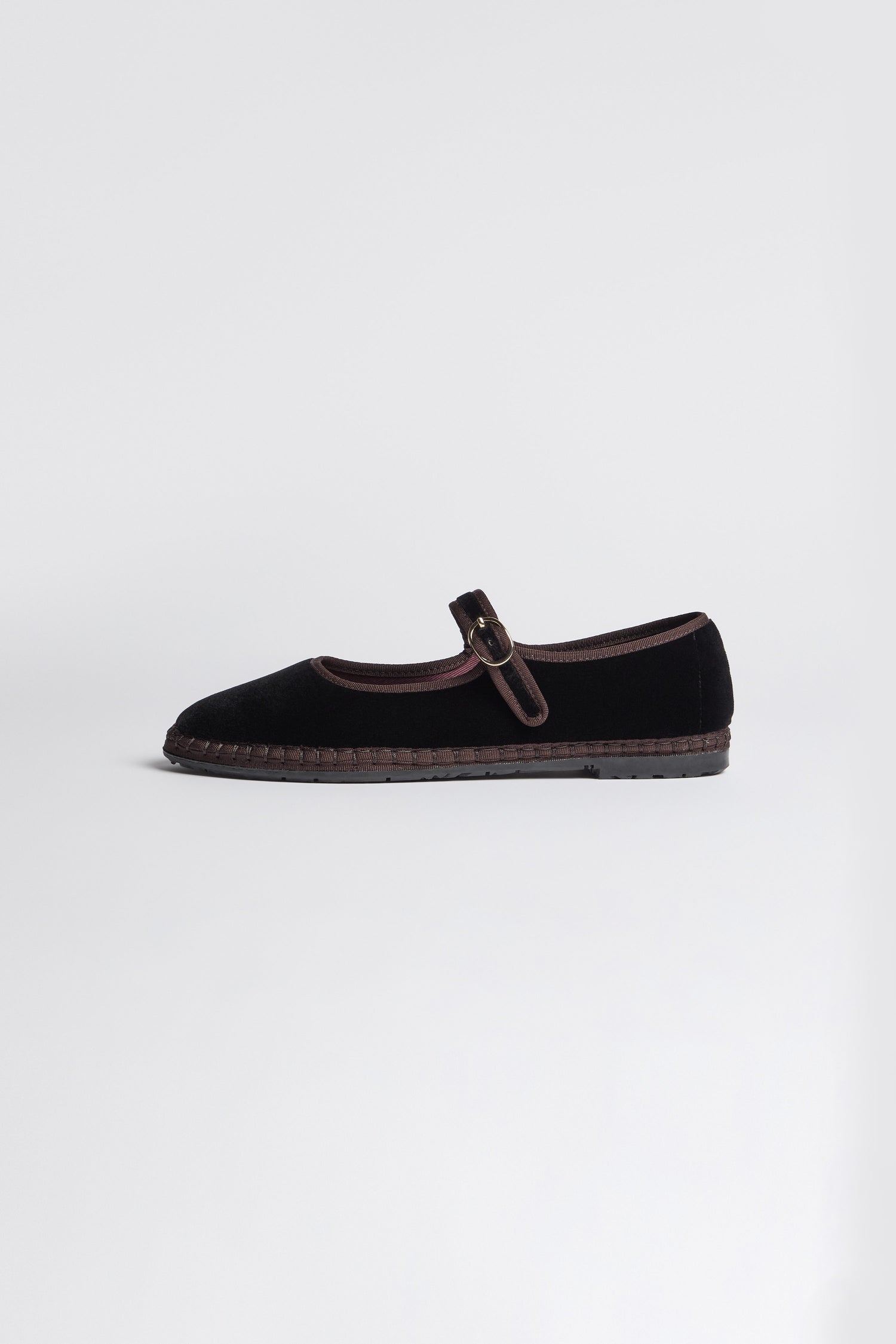 Black Mary Jane Velvet Shoes featuring a single buckle strap and brown trim, crafted with traditional Spanish shoemaking techniques, displayed on a plain light background.