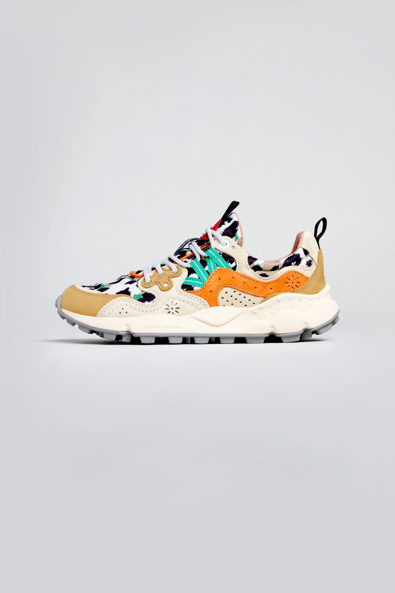 The Yamano 3 Leopard Suede Nylon Trainers are multicolored athletic shoes with beige, orange, black, white, and green accents, a chunky lightweight rubber sole, and a heel pull tab—ideal for hiking-inspired style on a plain background.