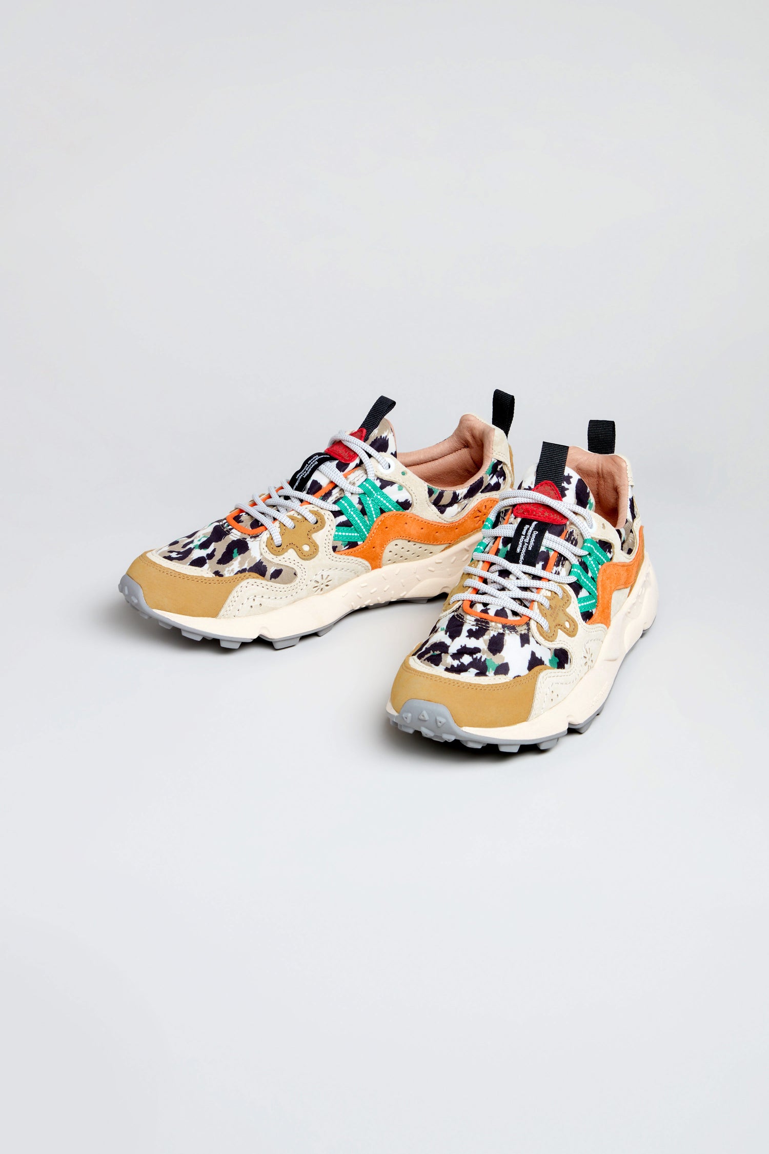 The Yamano 3 Leopard Suede Nylon Trainers feature a multicolored animal print, teal laces, orange and beige accents, and a lightweight rubber sole, shown on a plain background.