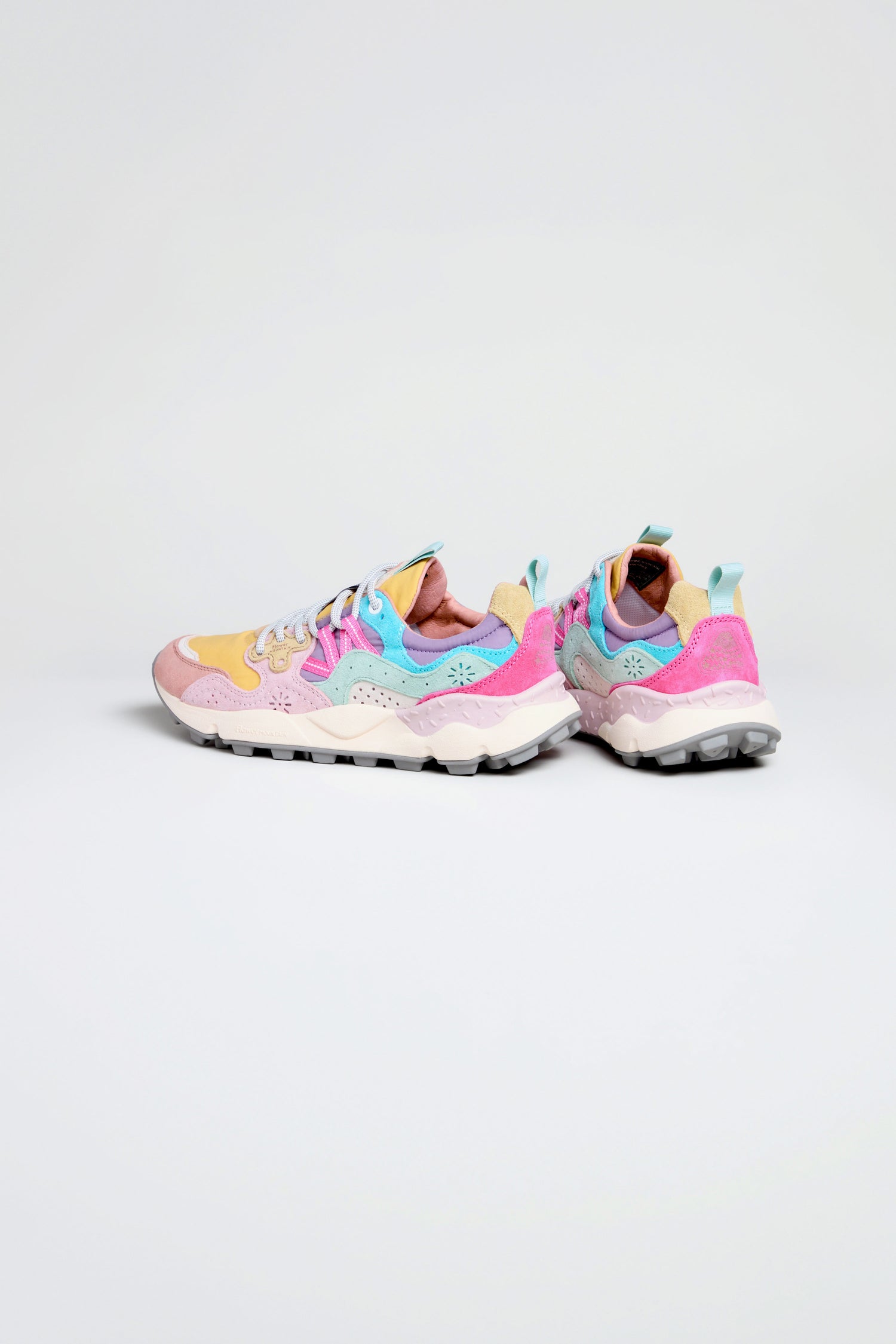 Two Dijon Yamano 3 Colour Pop Trainers in pastel tones with pink, blue, yellow, and beige panels are placed on a light background, facing slightly apart—an outdoor-inspired sneaker with vibrant style.