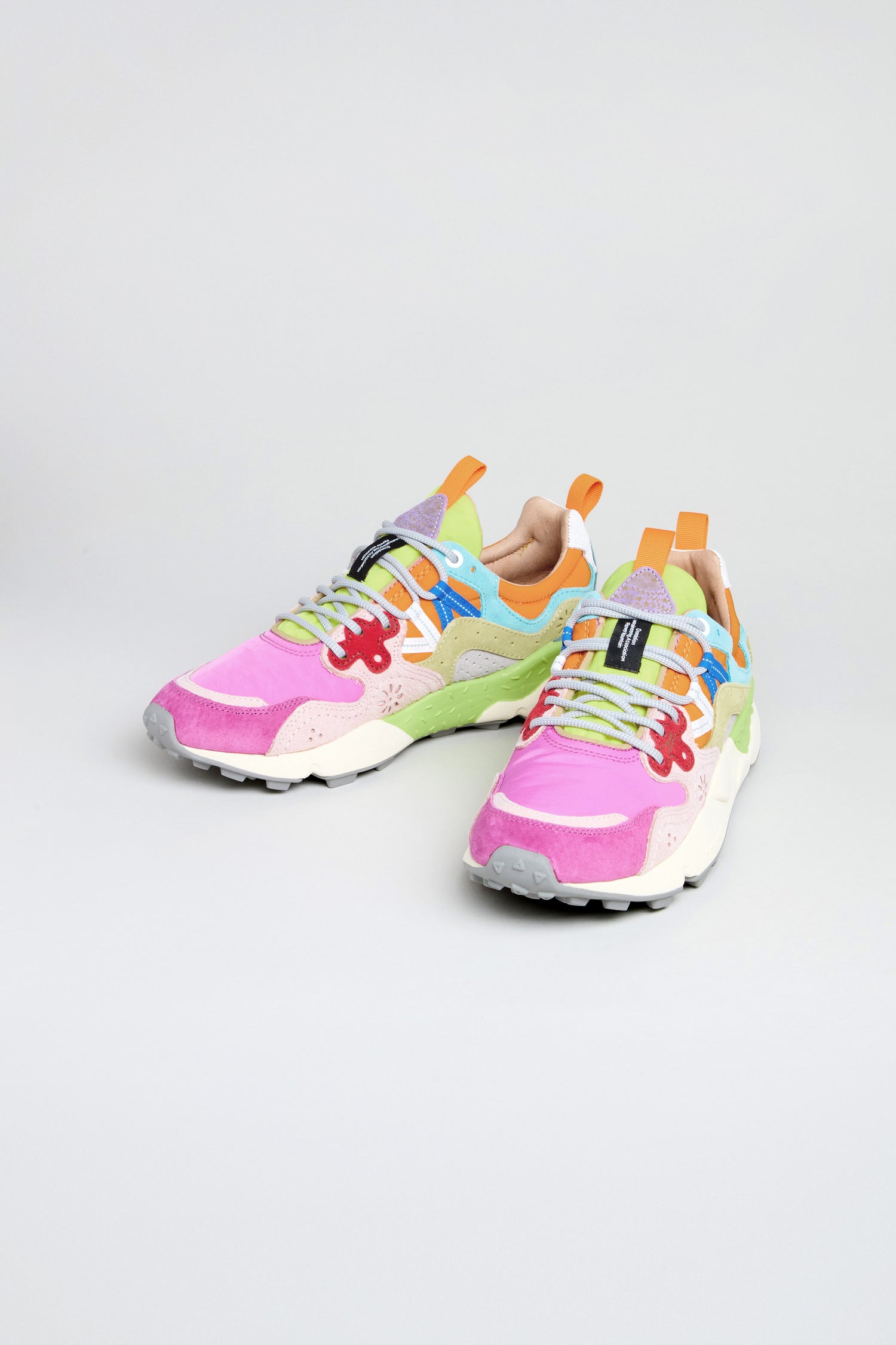 The Fuchsia Yamano 3 Colour Pop Trainers are vibrant women's outdoor sneakers with pink, green, purple, blue, orange, and white accents, shown on a plain light background.
