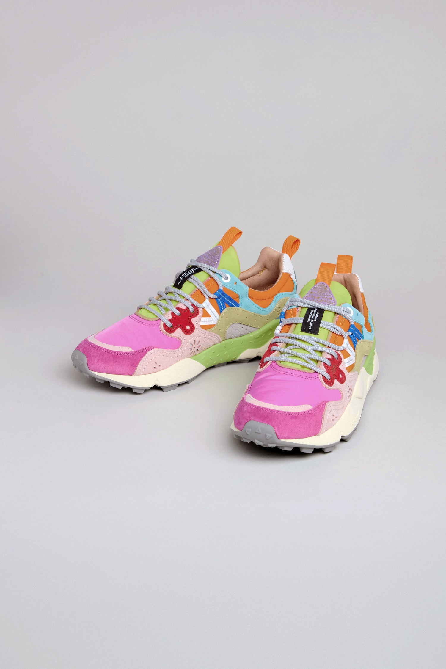 The Fuchsia Yamano 3 Colour Pop Trainers are vibrant women's outdoor sneakers with pink, green, purple, blue, orange, and white accents, shown on a plain light background.