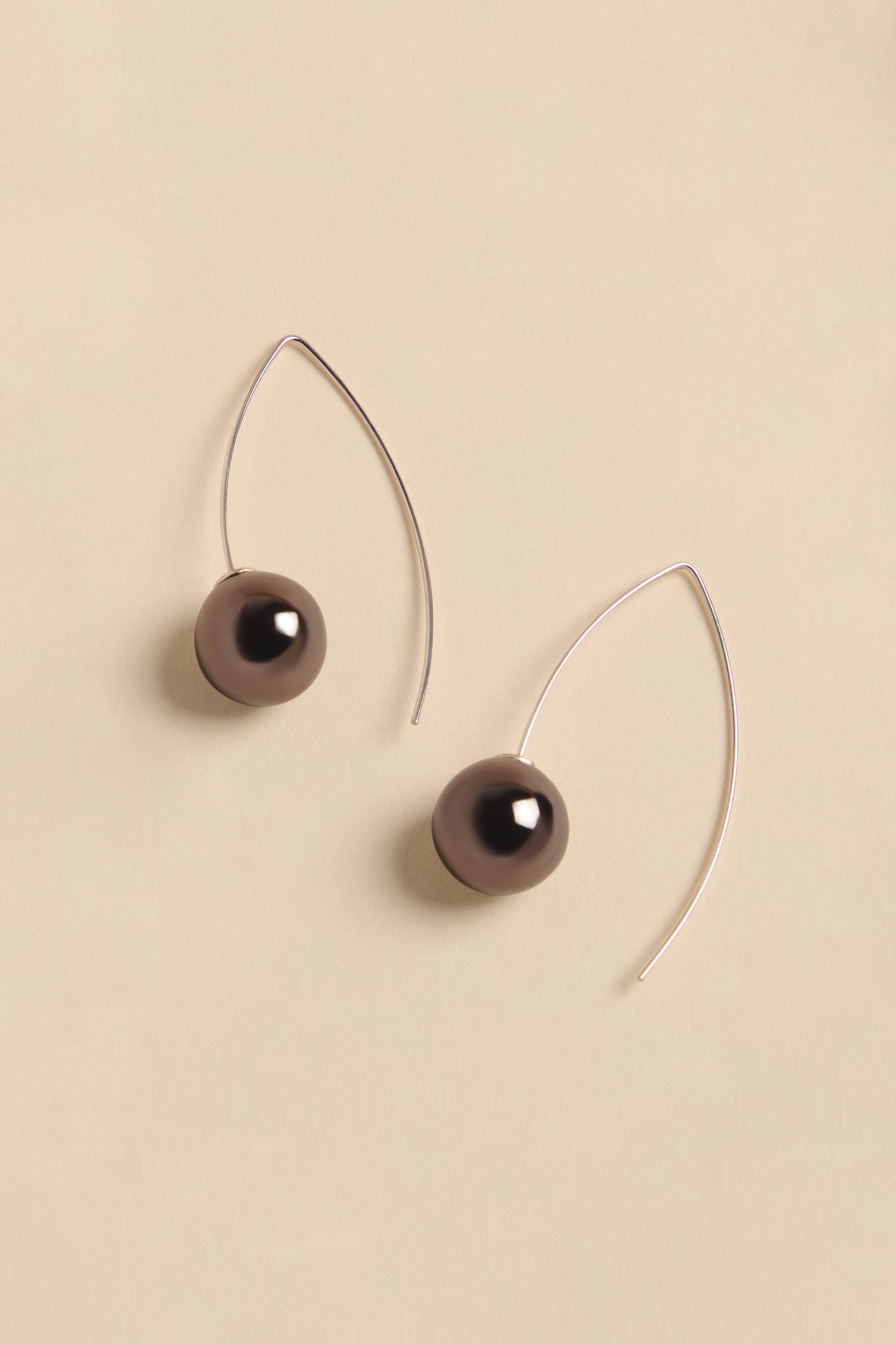 Handmade Charcoal Ceramic Bead Earrings featuring two dark charcoal-colored ceramic beads on thin silver curved wires.