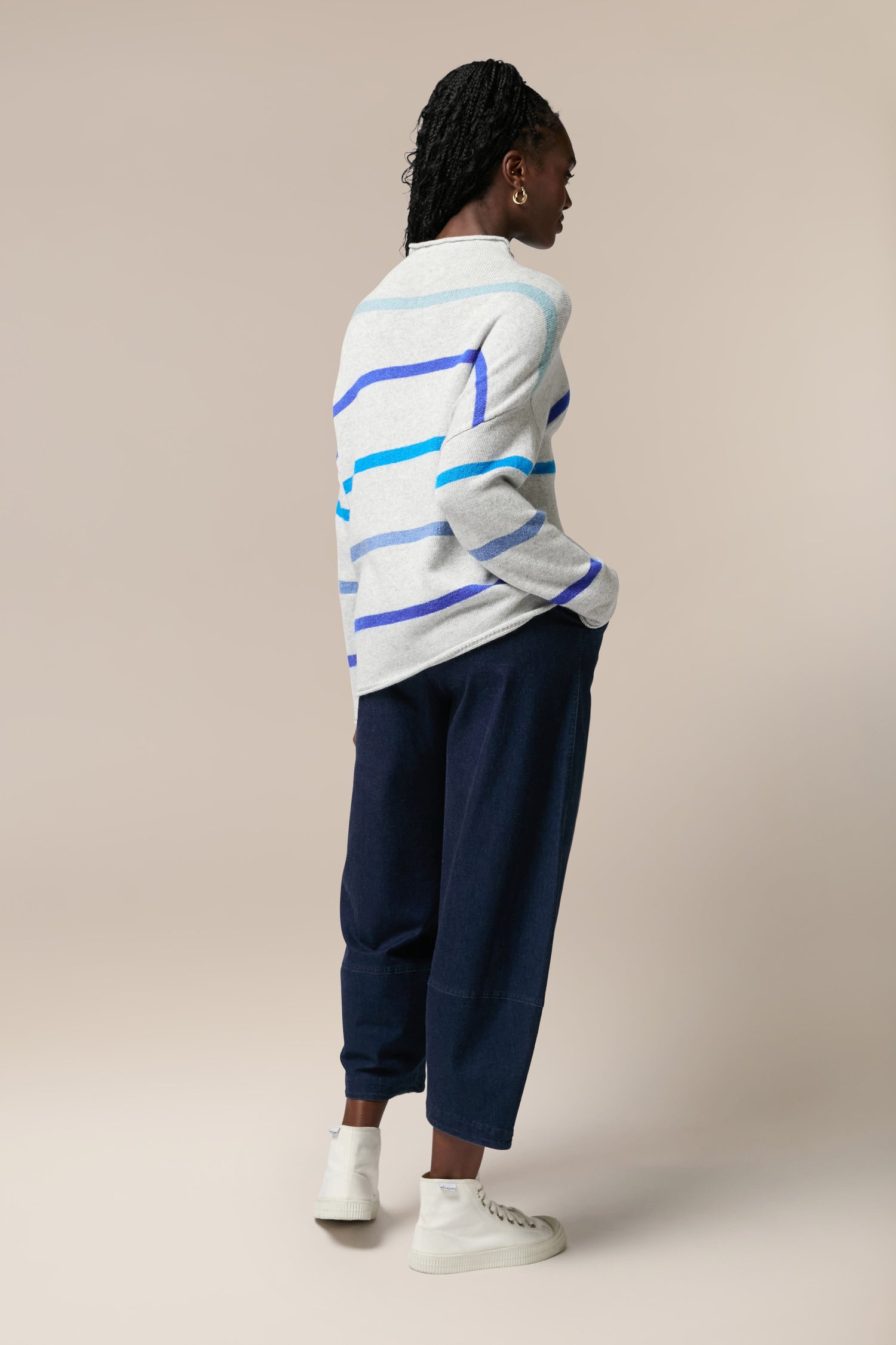 The back view of a woman wearing a Mohair Blend Stripe Sweater.