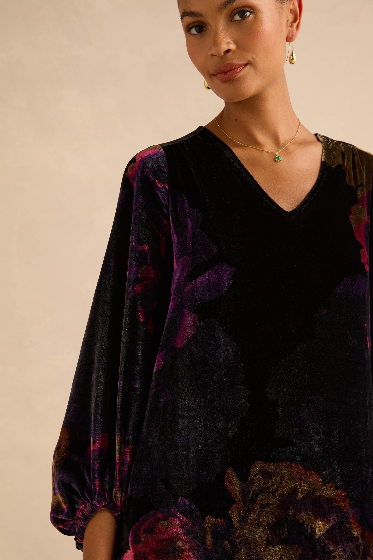 Midnight Peonies Velvet Dress, a black midi dress with a V-neck, long puffed sleeves, and a dark purple and gold photographic floral print.