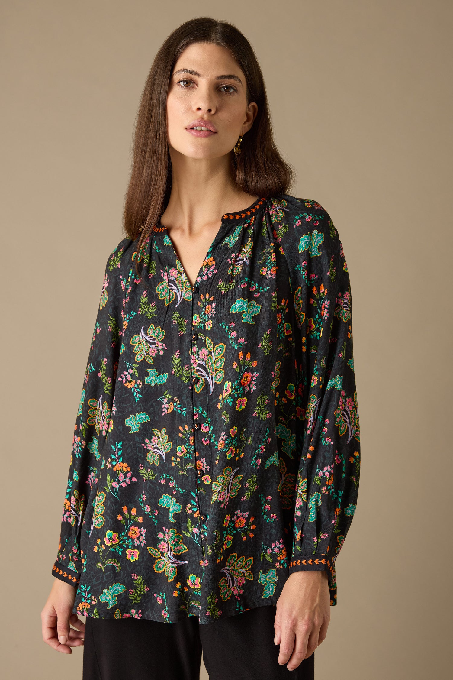 Against a plain background, a woman effortlessly exudes charm in the Hand Drawn Floral Boxy Shirt.