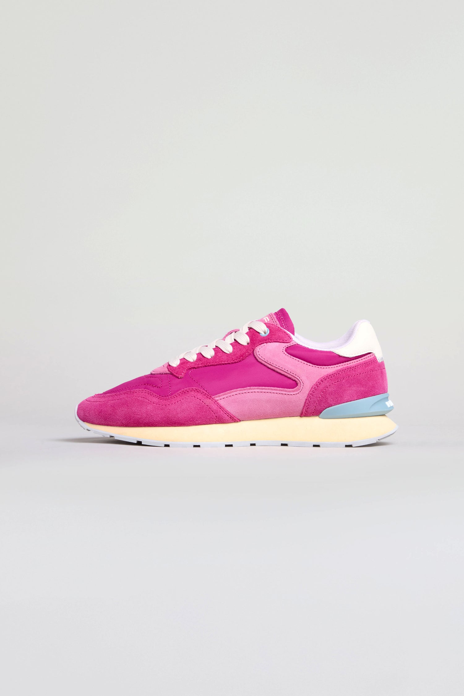 The City Retro Trainers are shown from the side, featuring pink suede and mesh, white laces, light pink accents, a blue heel detail, beige sole, and a memory foam insole for all-day comfort.