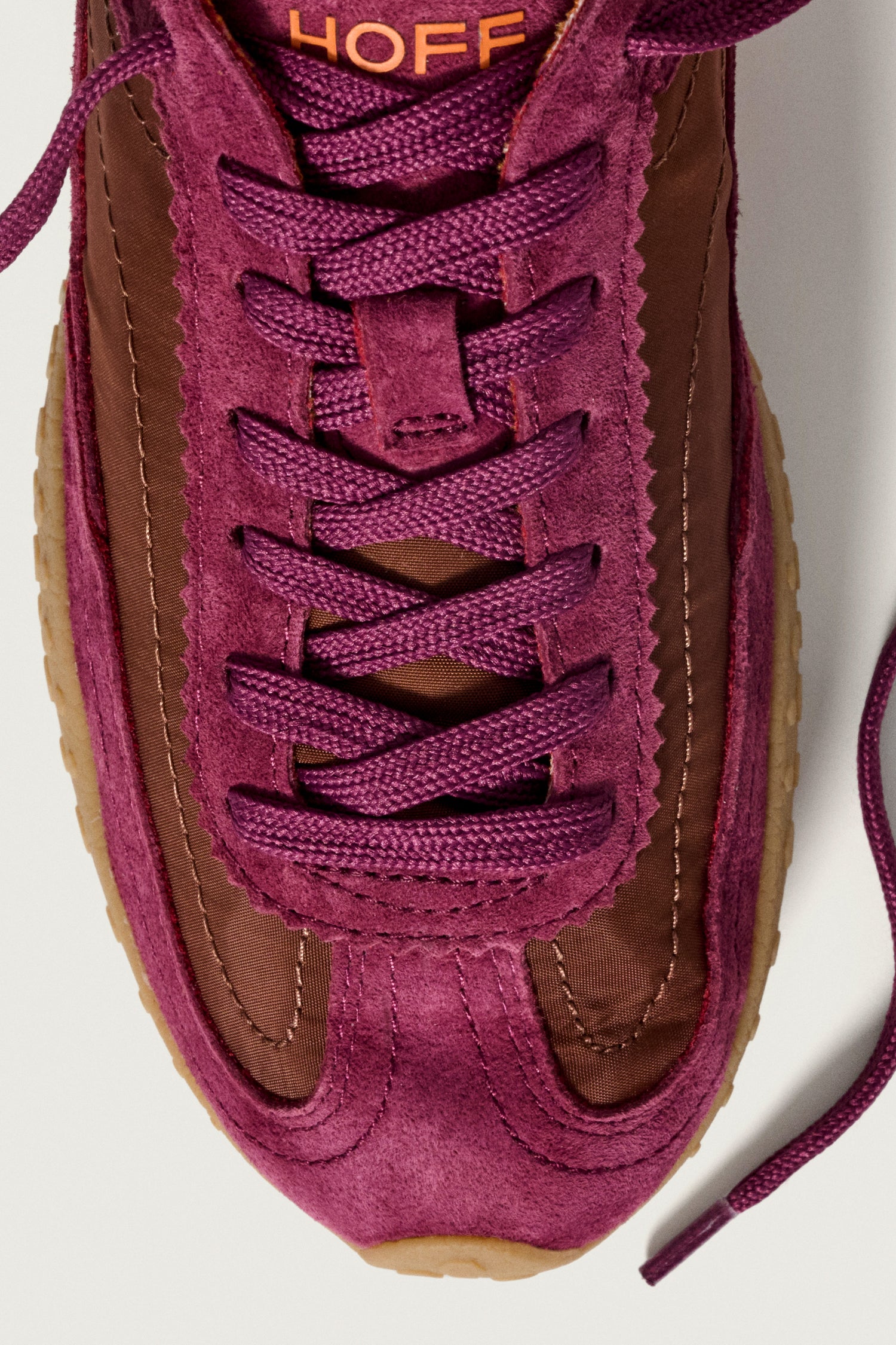 Close-up of Burgundy Bridge Trainers featuring purple suede, brown leather panels, purple laces, and a light brown gum sole. "HOFF" branding on the tongue—an ideal choice for comfortable everyday wear.