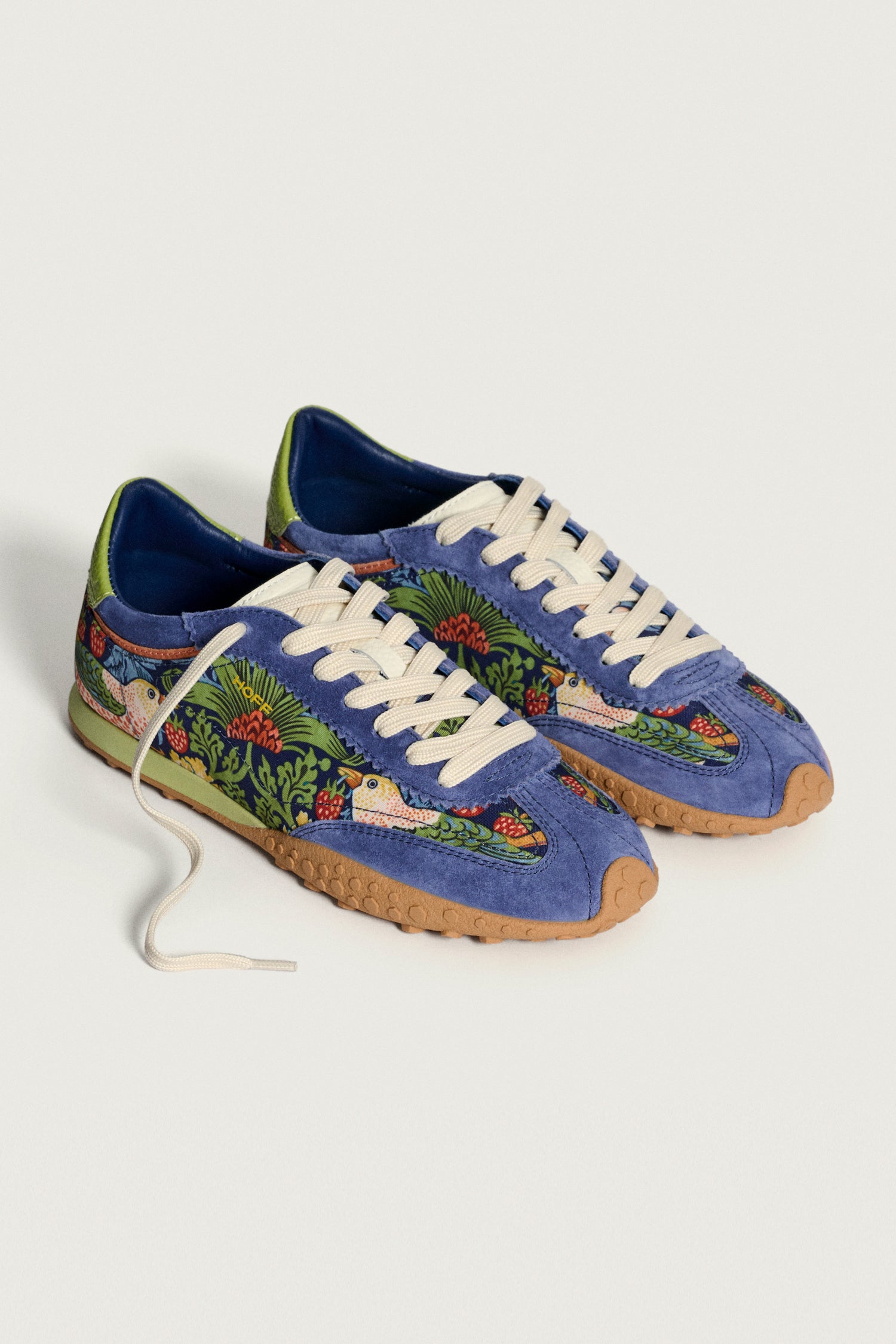 The Blue William Morris Bridge Trainers feature beige laces, gum soles, and vibrant floral and bird patterns inspired by the Strawberry Thief print—perfect for fans of artistic women’s footwear.