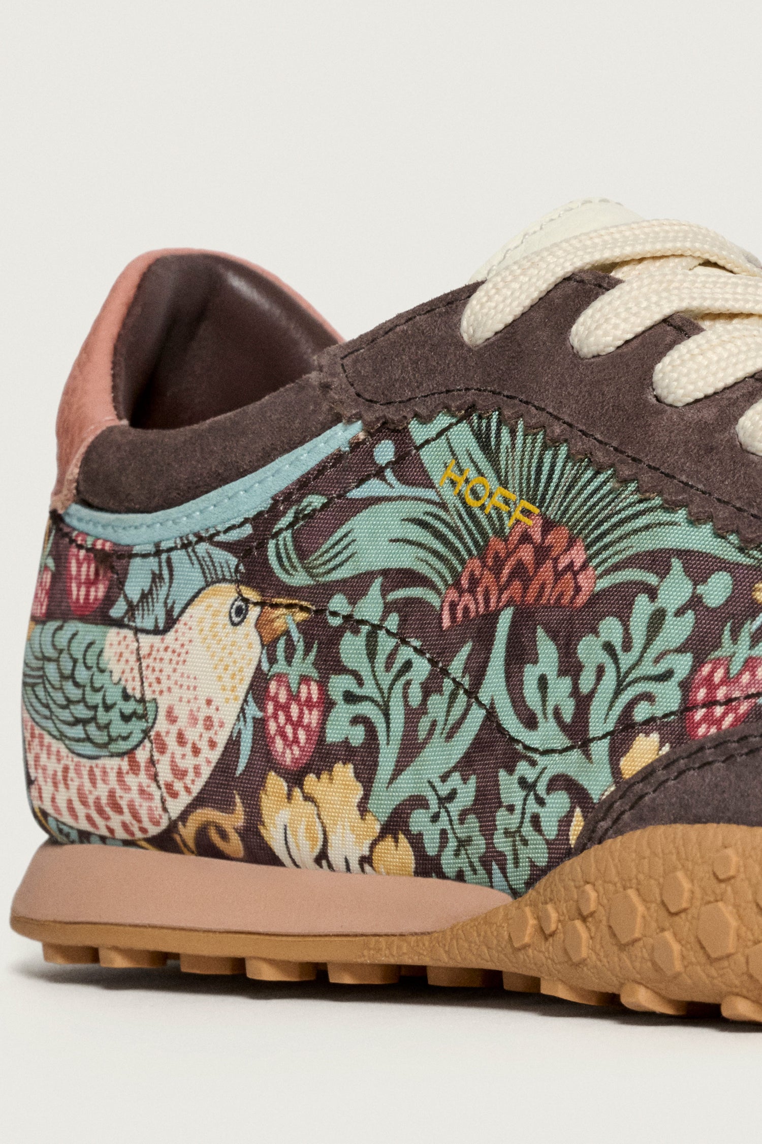 A close-up of the Brown William Morris Bridge Trainers, showcasing the iconic Strawberry Thief design with birds, plants, and berries, cream laces, and a textured brown sole.