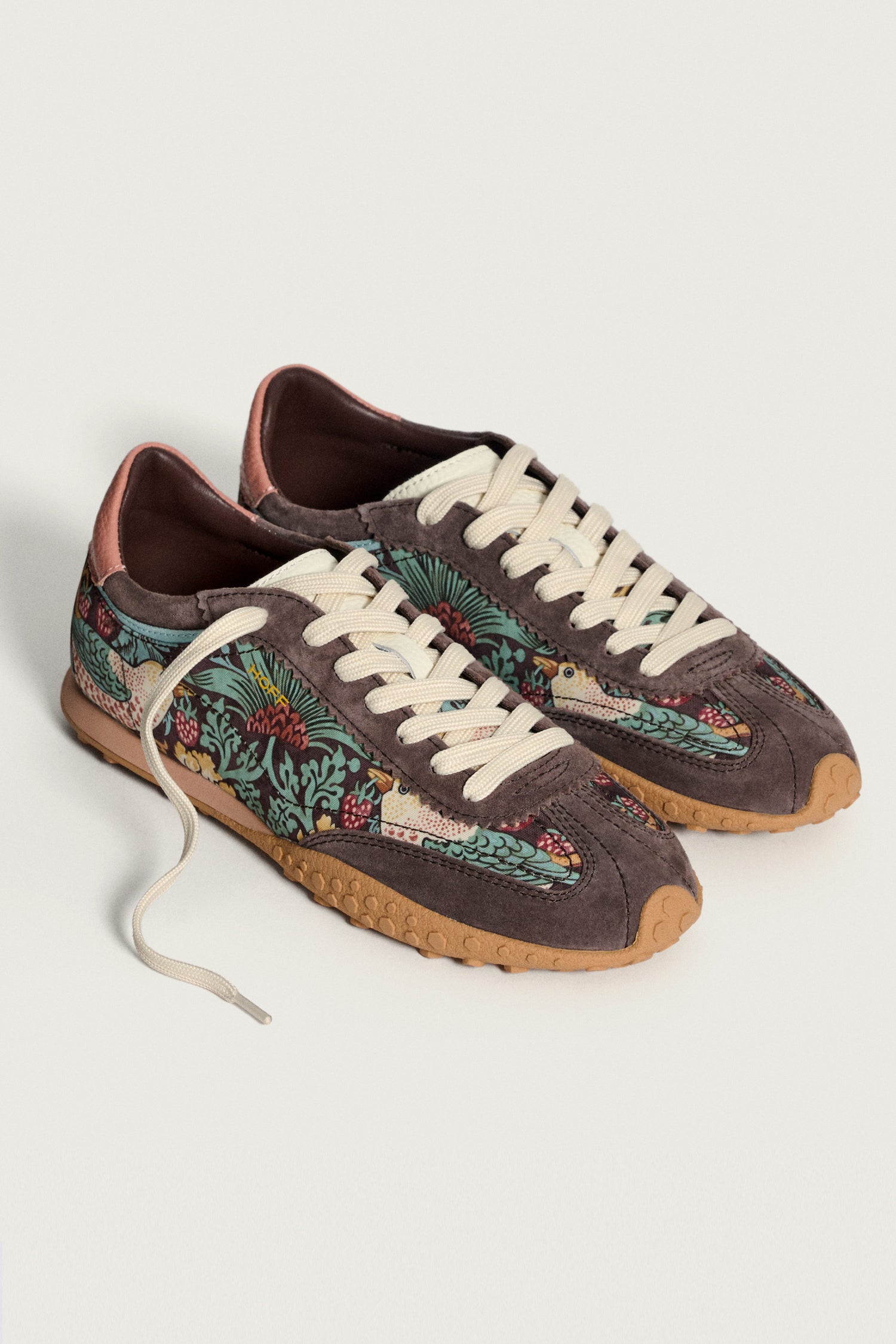 Brown William Morris Bridge Trainers featuring beige laces, brown suede details, gum soles, and a multicolored Strawberry Thief design on the sides, displayed against a plain background.