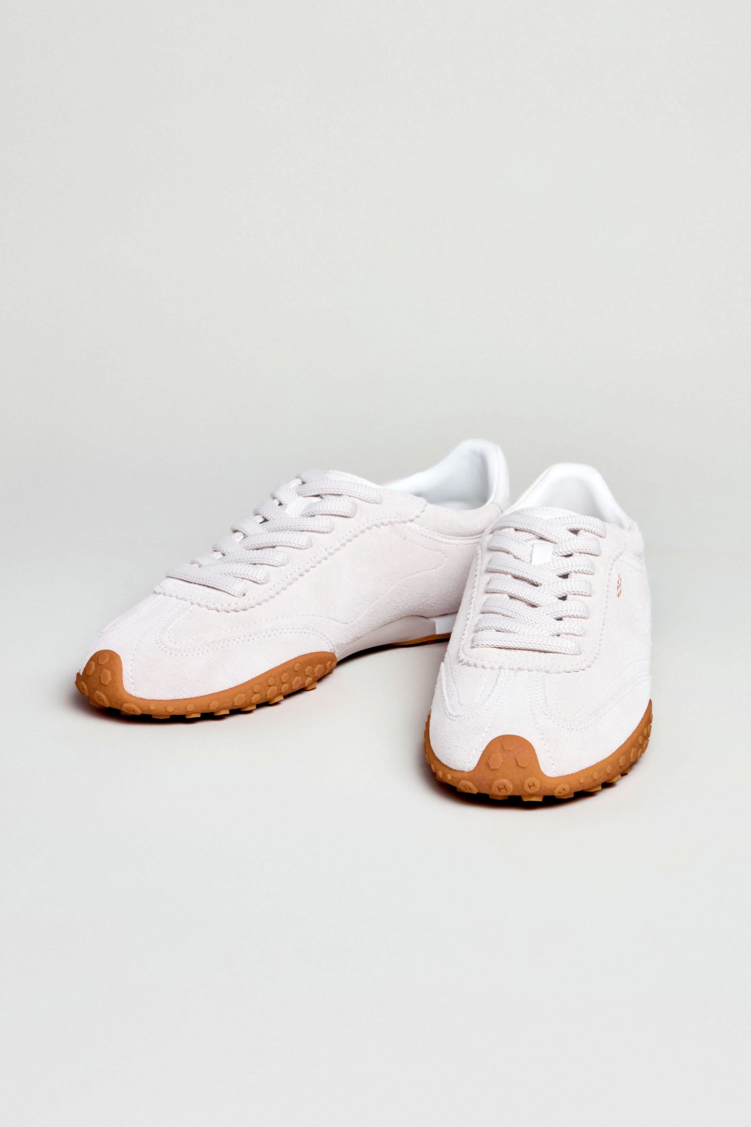 A pair of Bridge Light Grey Suede Trainers with gum rubber soles placed on a plain light background.