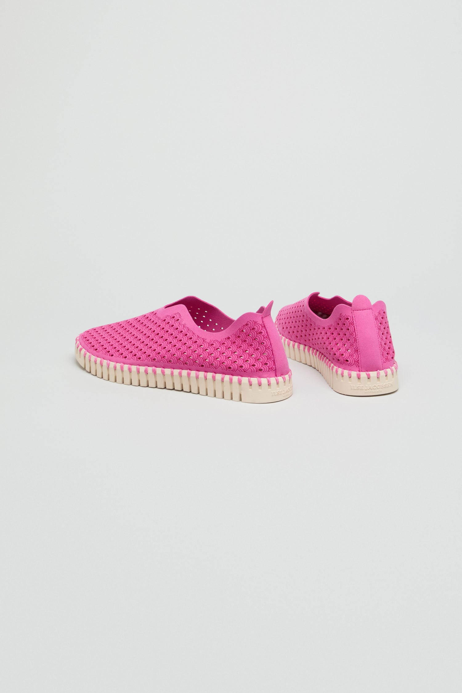 Rose Tulip Slip on Shoes in bright pink feature perforated uppers and white textured soles for lightweight comfort, showcased on a plain white background.