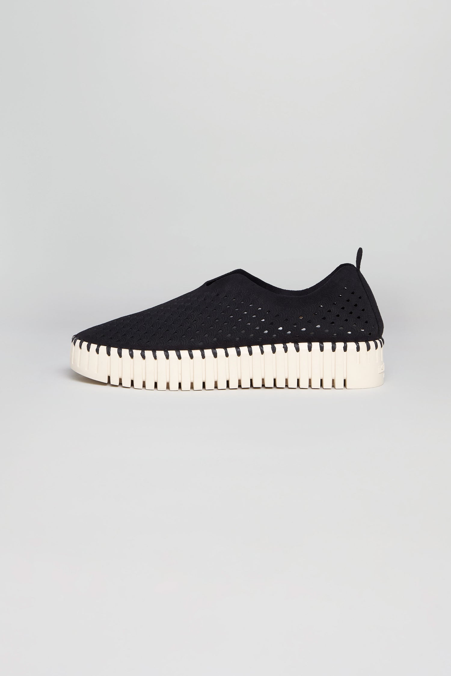 The Black Tulip Platform Slip On Shoes feature a perforated black upper and thick white sole, highlighting Ilse Jacobsen's signature style. Shown against a plain light gray background.