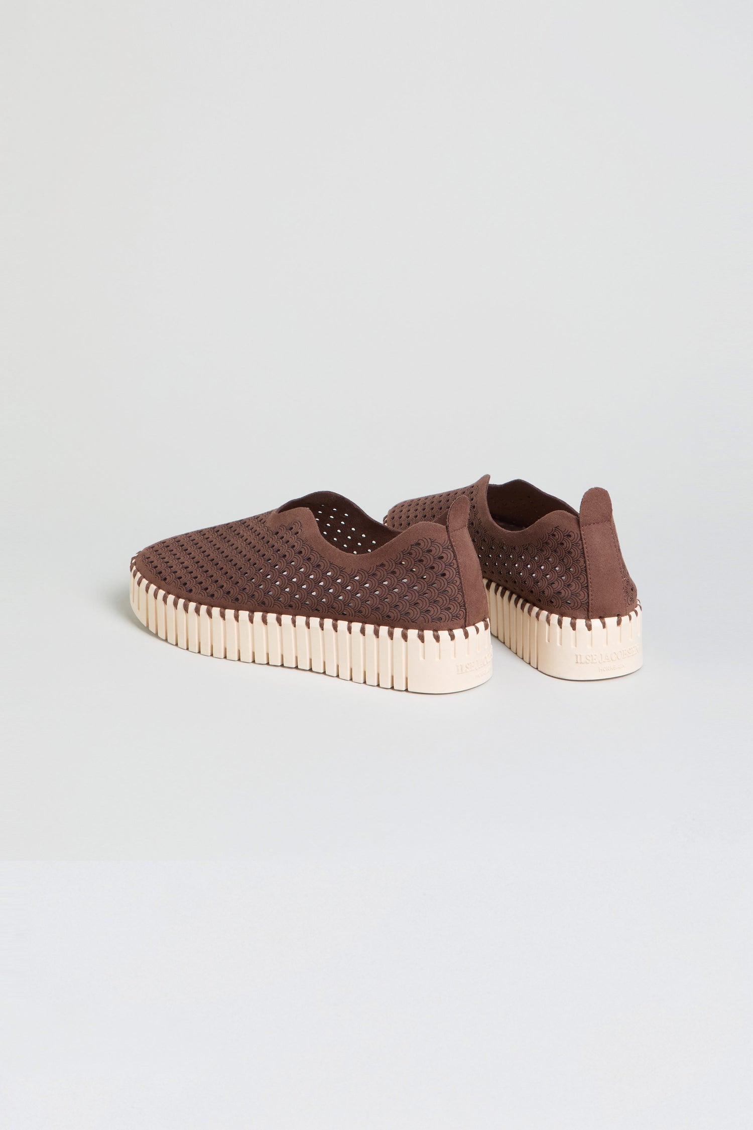 A pair of Tulip Platform Slip On Shoes in brown, crafted from recycled microfiber with perforated uppers for breathability and thick, light-colored ridged soles, are displayed against a simple light background.