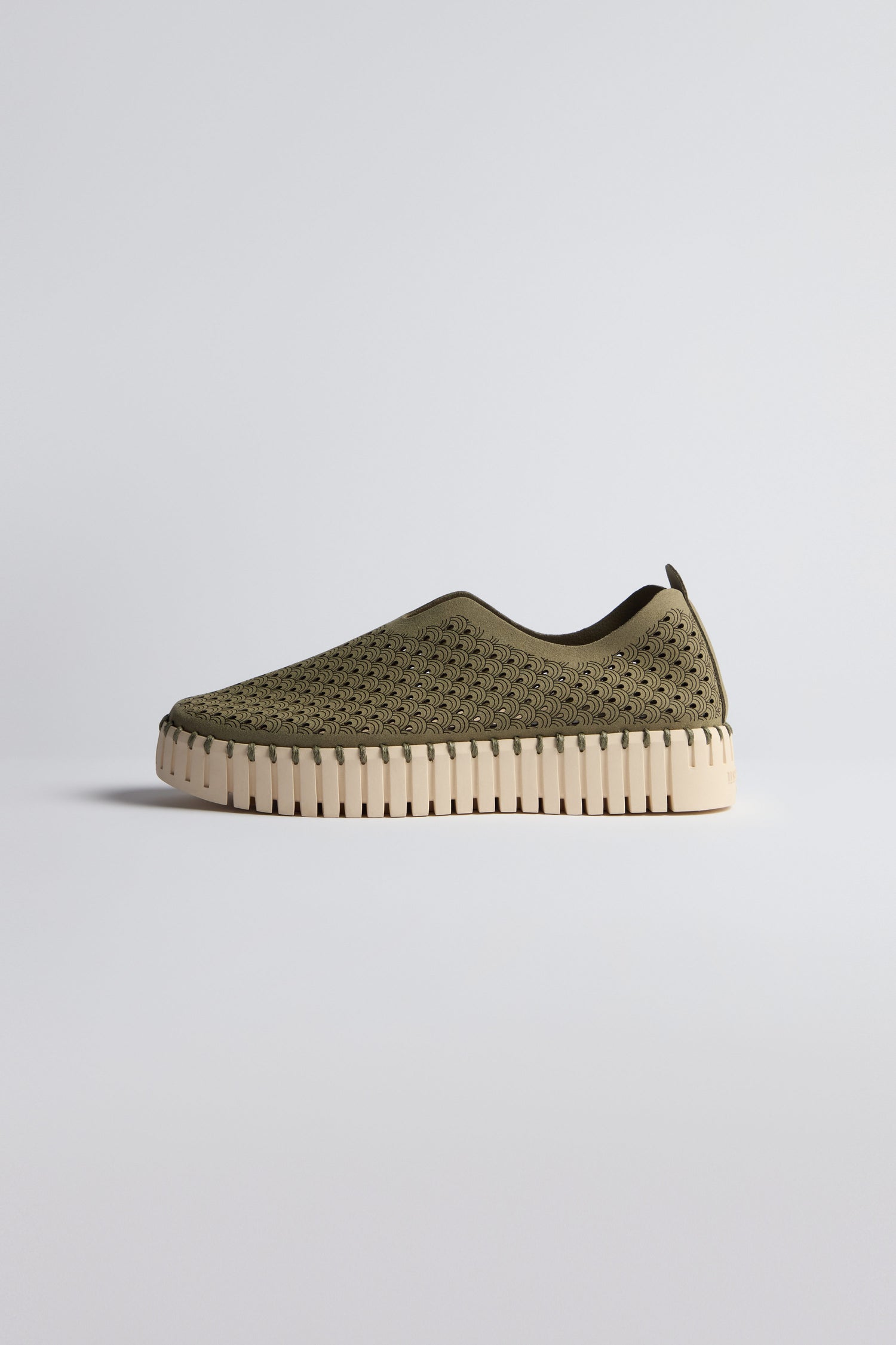 A Khaki Tulip Platform Slip On Shoe with a perforated upper and a thick cream-colored sole is shown against a light background.