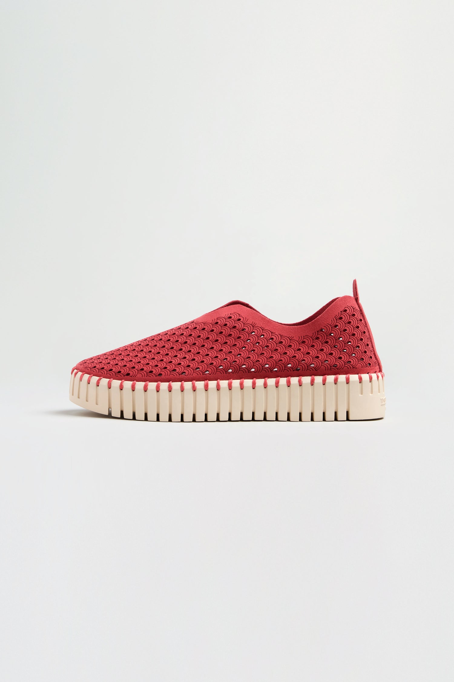 The Tulip Platform Slip on Shoe in red features a textured woven upper and a thick off-white ribbed sole, displayed in profile against a plain background.