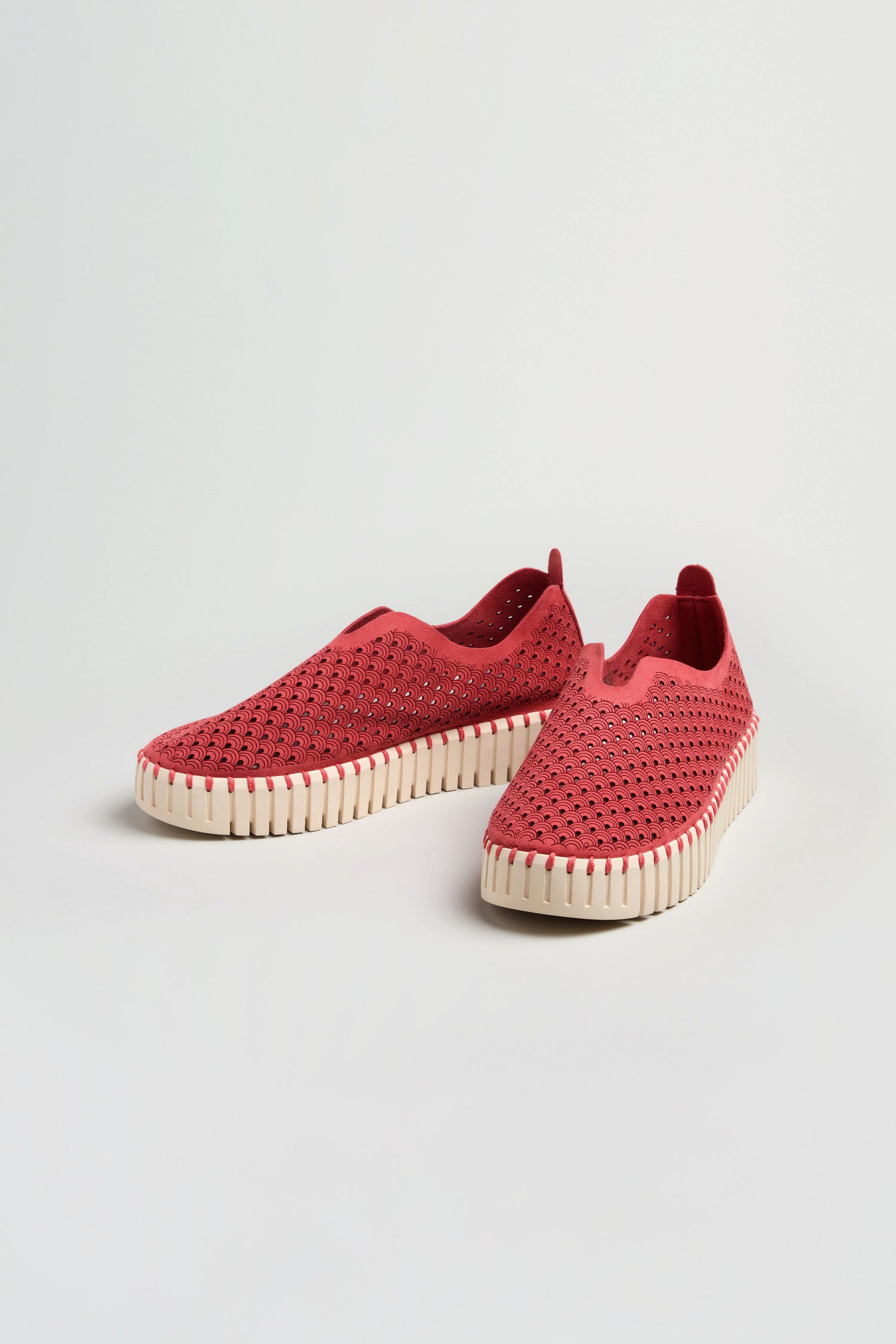 A pair of Tulip Platform Slip on Shoes, featuring red recycled microfibre with perforated uppers and white ridged soles, displayed on a white background.