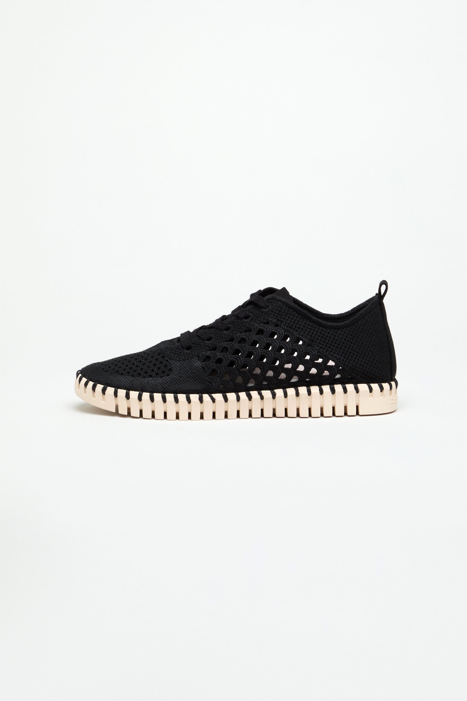 A side-profile view of the Tulip Embroidered Lace Up Trainers, featuring a black mesh perforated upper and a white segmented rubber sole, displayed against a plain white background.
