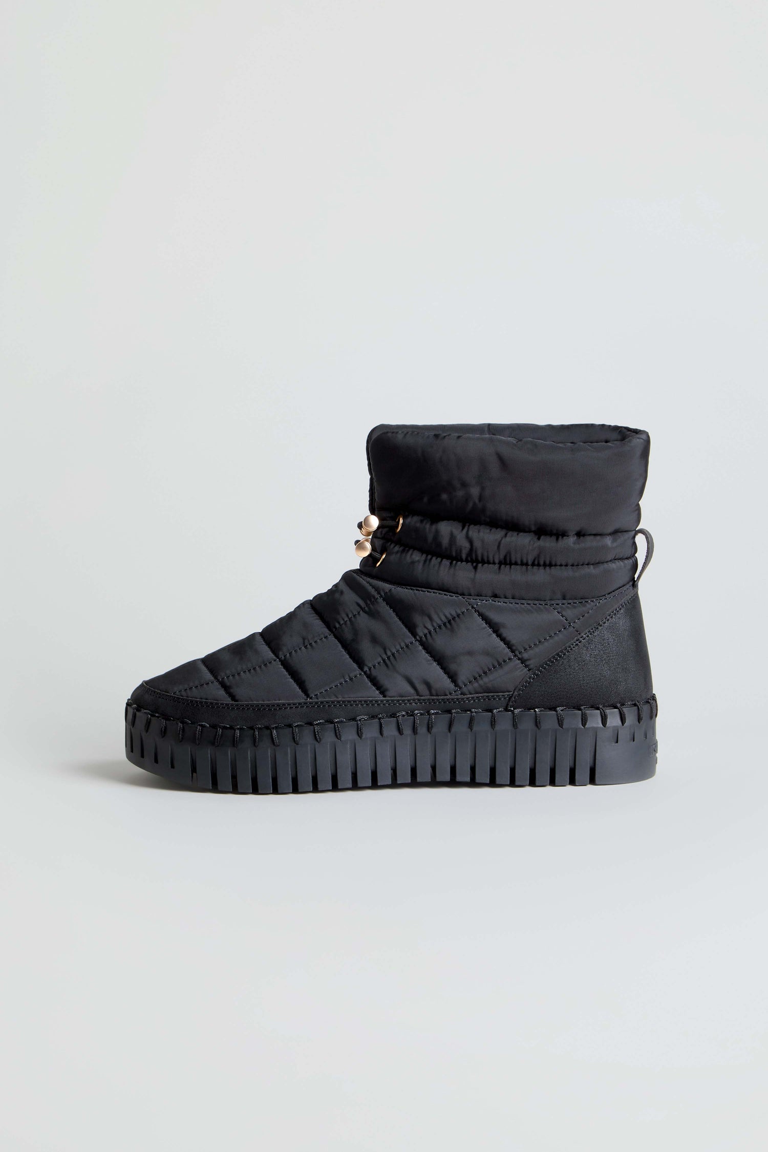 Tulip Quilted Winter Boots featuring a cushioned sole and high collar, in black, photographed against a plain light gray background.