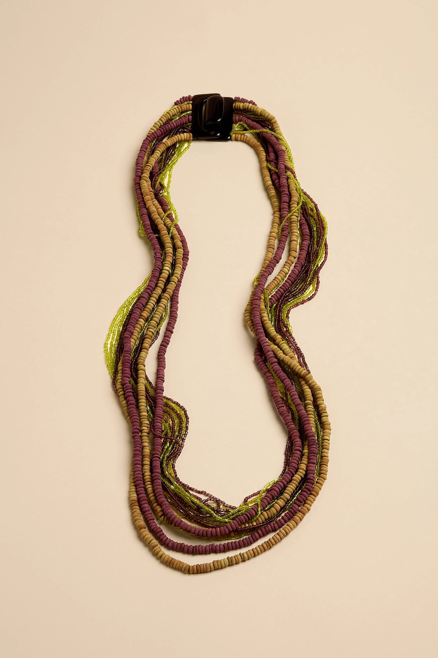 Mango Wood & Bead Waterfall Necklace featuring multi-strand beads in shades of green, brown, and plum with a dark rectangular clasp.