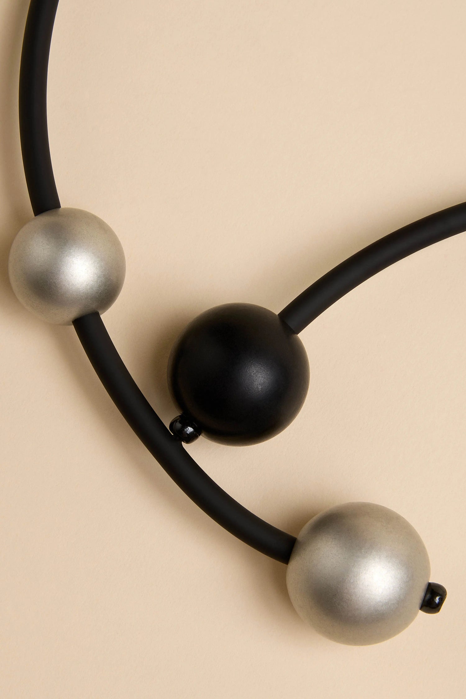 Triple Sphere Statement Necklace featuring two silver spheres and one black central sphere.