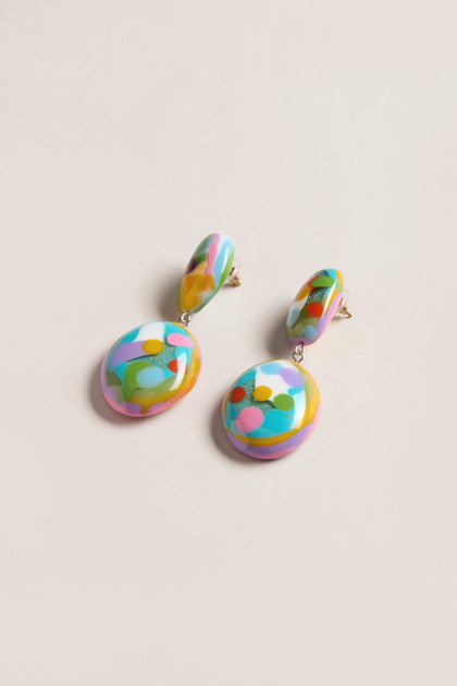 The Kandinsky Duo Pebble Earrings feature round, colorful abstract designs with multicolored patterns on a light background, adding a playful, sculptural touch to any outfit.