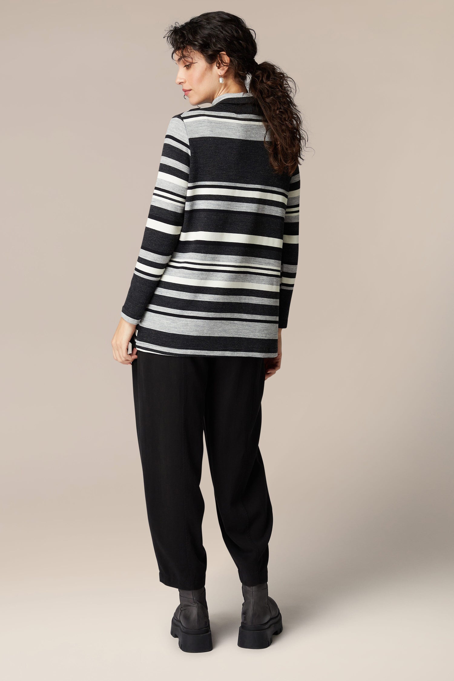 The back view of a woman wearing a black and white Jersey Stripe Knit Polo Top.