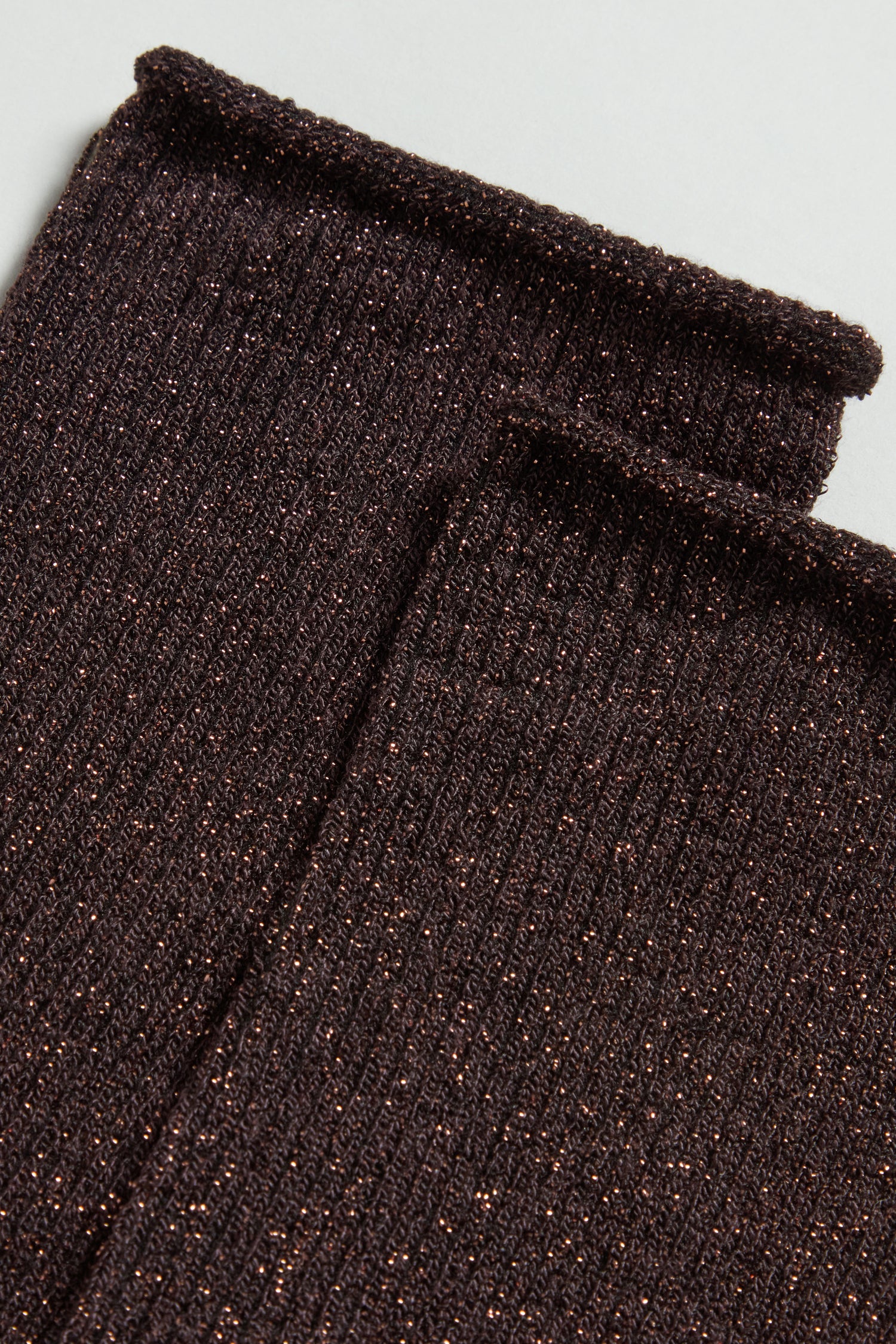 Close-up of Bamboo Sparkle Chocolate Socks in dark brown, featuring a ribbed design and metallic threads woven throughout for a subtle shimmer.