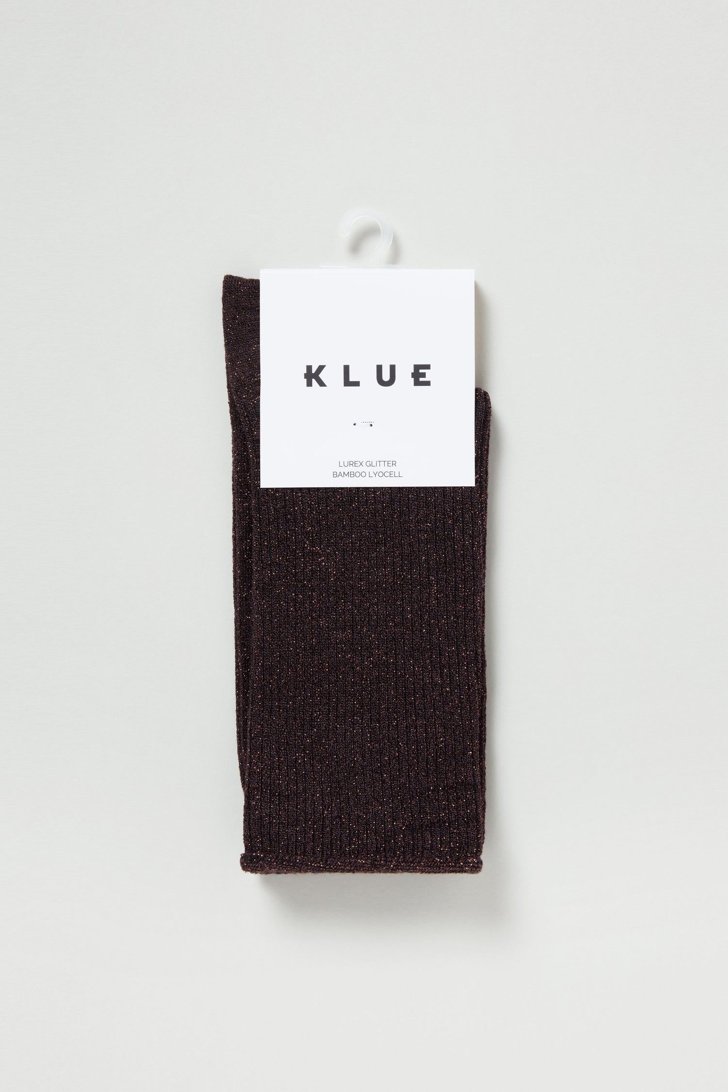 A pair of Bamboo Sparkle Chocolate Socks with ribbed texture and metallic threads, folded and packaged with a white label featuring the brand name "KLUE.