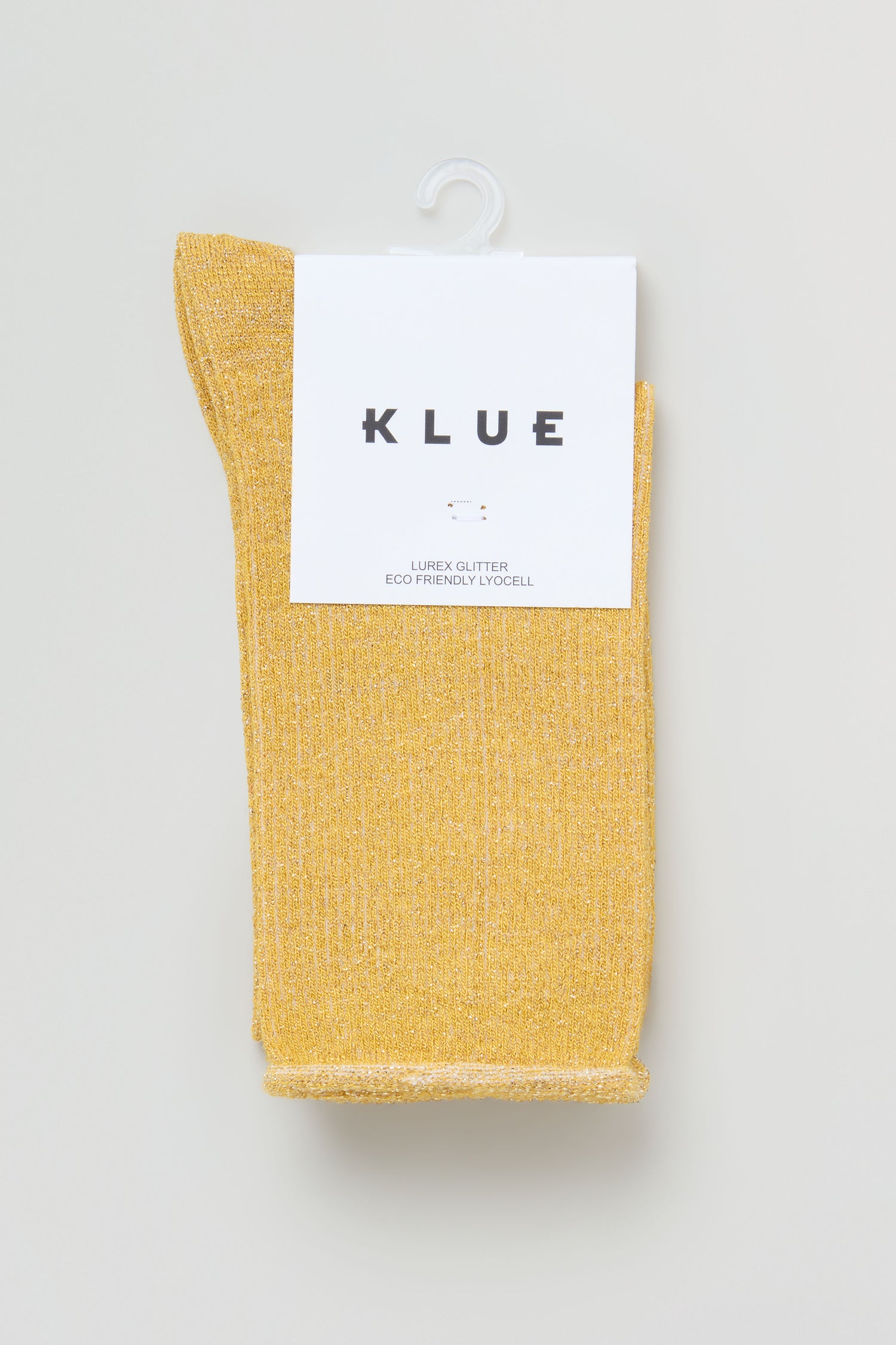 A pair of Bamboo Sparkle Dijon Socks, featuring yellow metallic lurex and labeled "KLUE," showcased in minimalist packaging on a white background.
