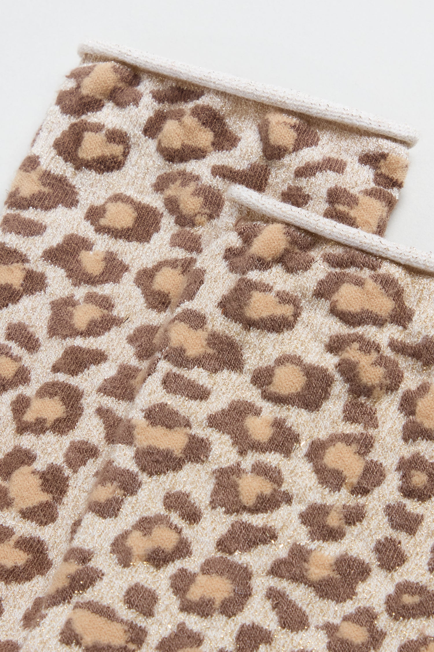 Close-up of Bamboo Leopard Print Socks with a brown and beige leopard pattern on a light background.