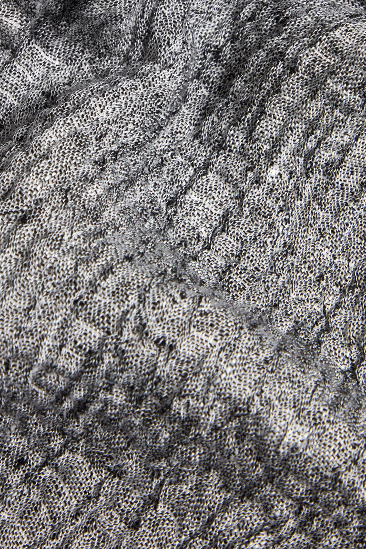 Close-up of textured grey crinkle linen, showing the detailed stitching and woven patterns on our Crinkle Double Face Linen Bubble Trouser.
