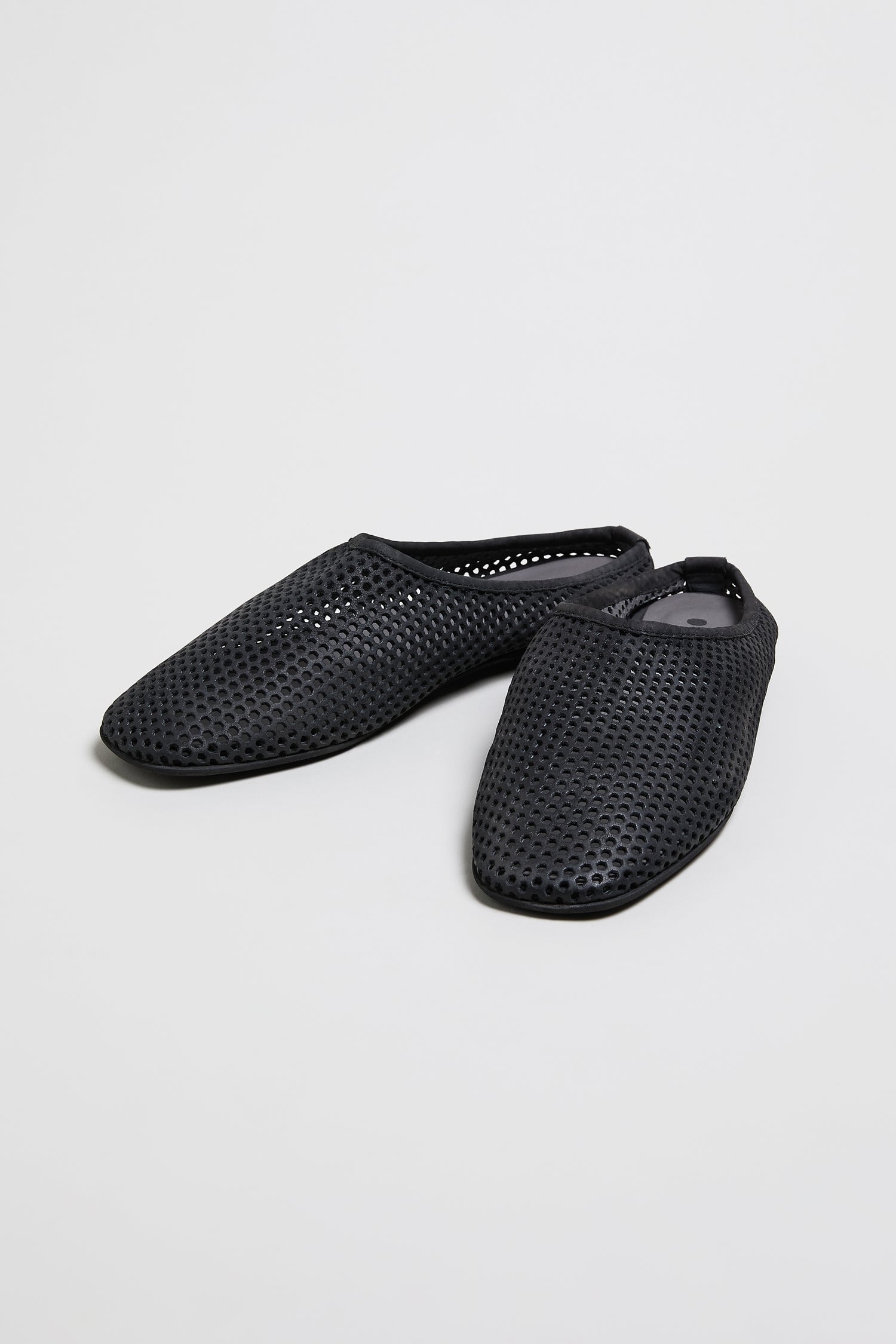 A pair of Mesh Leather Slip on Shoes in black with a rounded toe, shown on a plain white background. Style SS26 LOFI10042—coming soon.